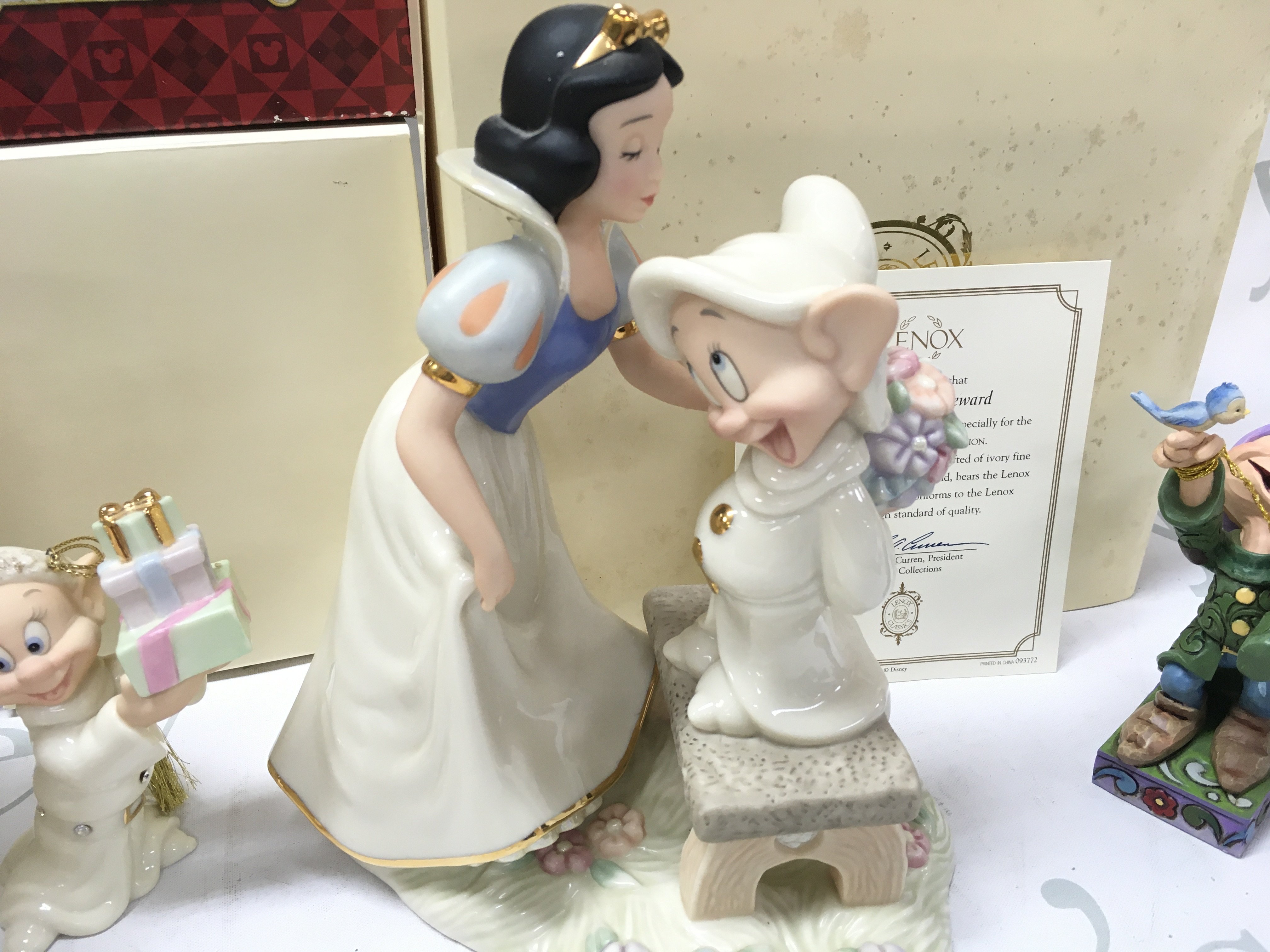 A collection of boxed Disney porcelain Lenox figures including Dopeys Sweet Reward, Dopey and Sneezy salt and pepper set , Dopey showcase , Votive vase