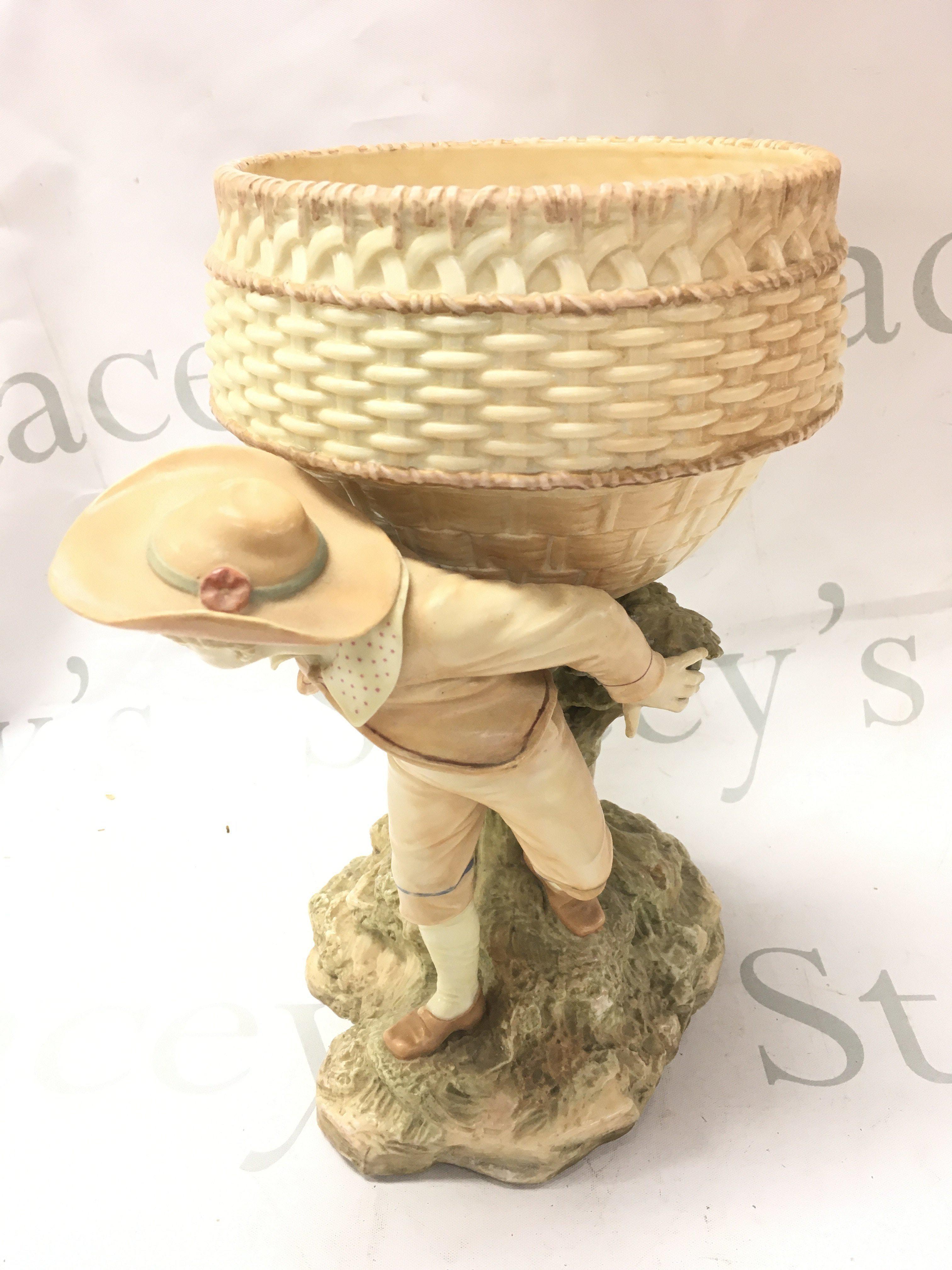 A Royal Worcester porcelain centre piece, with shaped bowl, on a tree bough aside figure 18cm tall. This lot cannot be posted