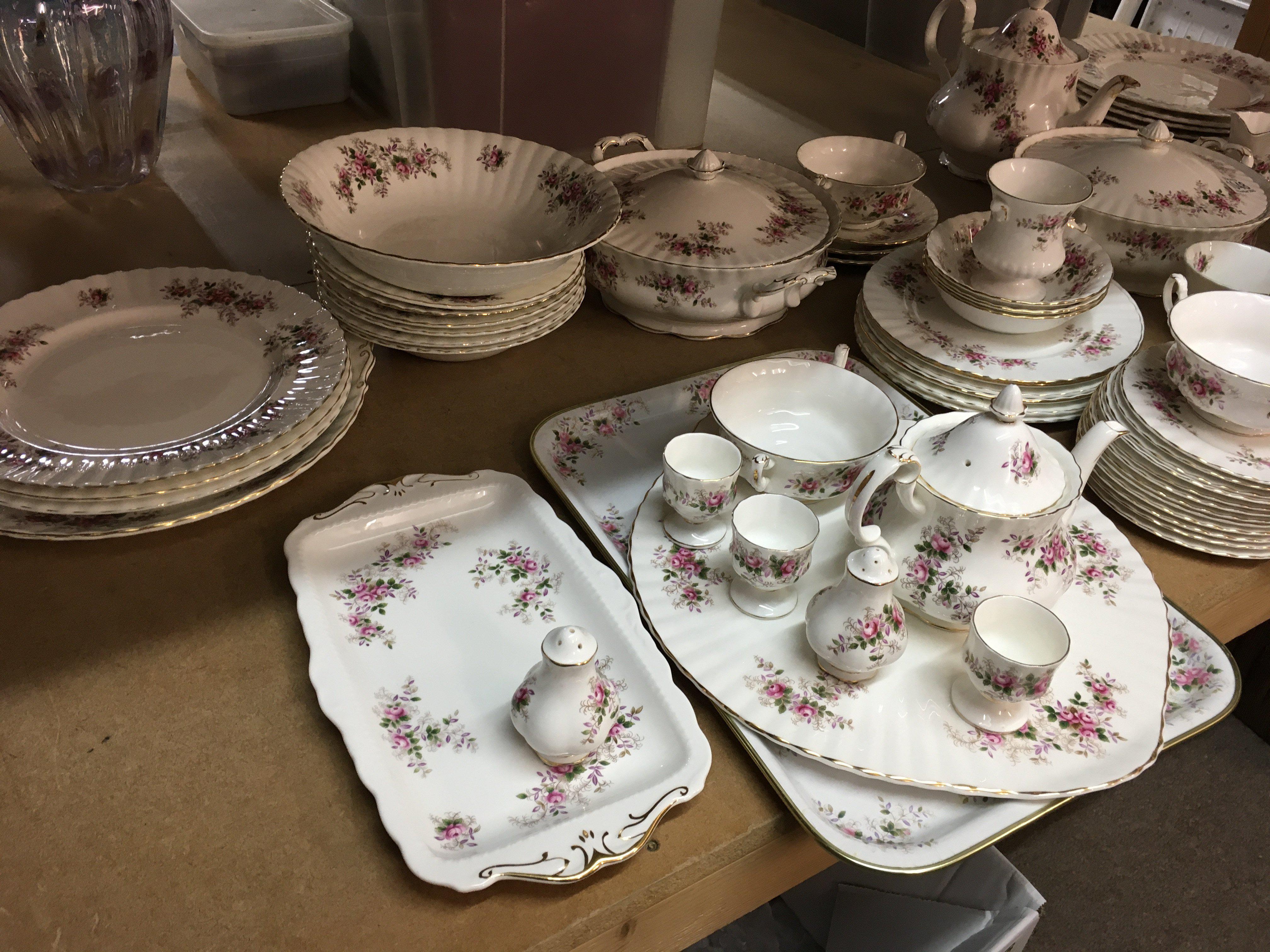 A Royal Albert Lavender rose dinner tea set including tea cups saucers dinner plates serving plates tureens serving plates and bowls .