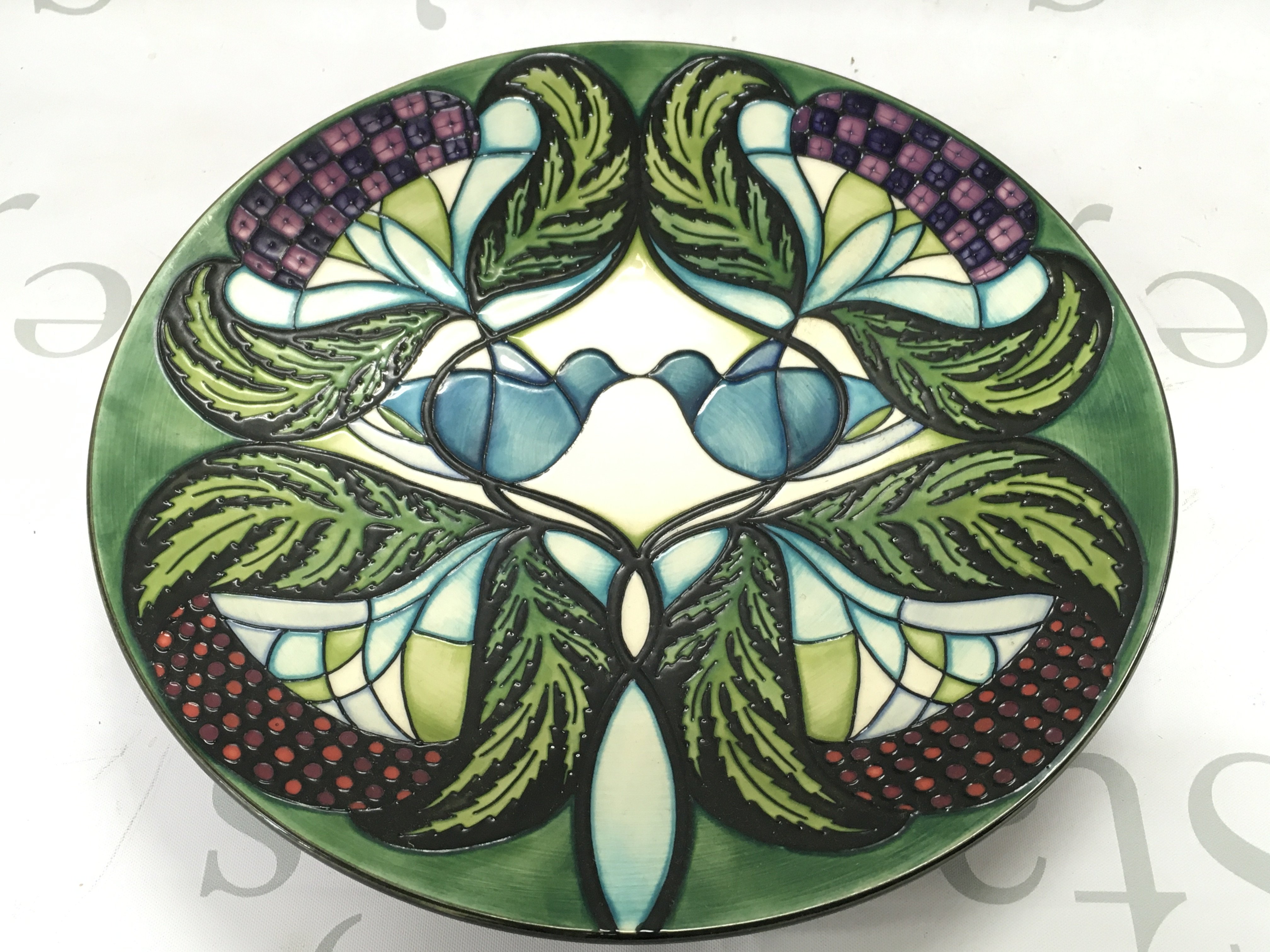 Moorcroft pottery circular charger decorated in the Blackwell by Nicola Slaney, dated 2008, , 28cm wide. This lot cannot be posted