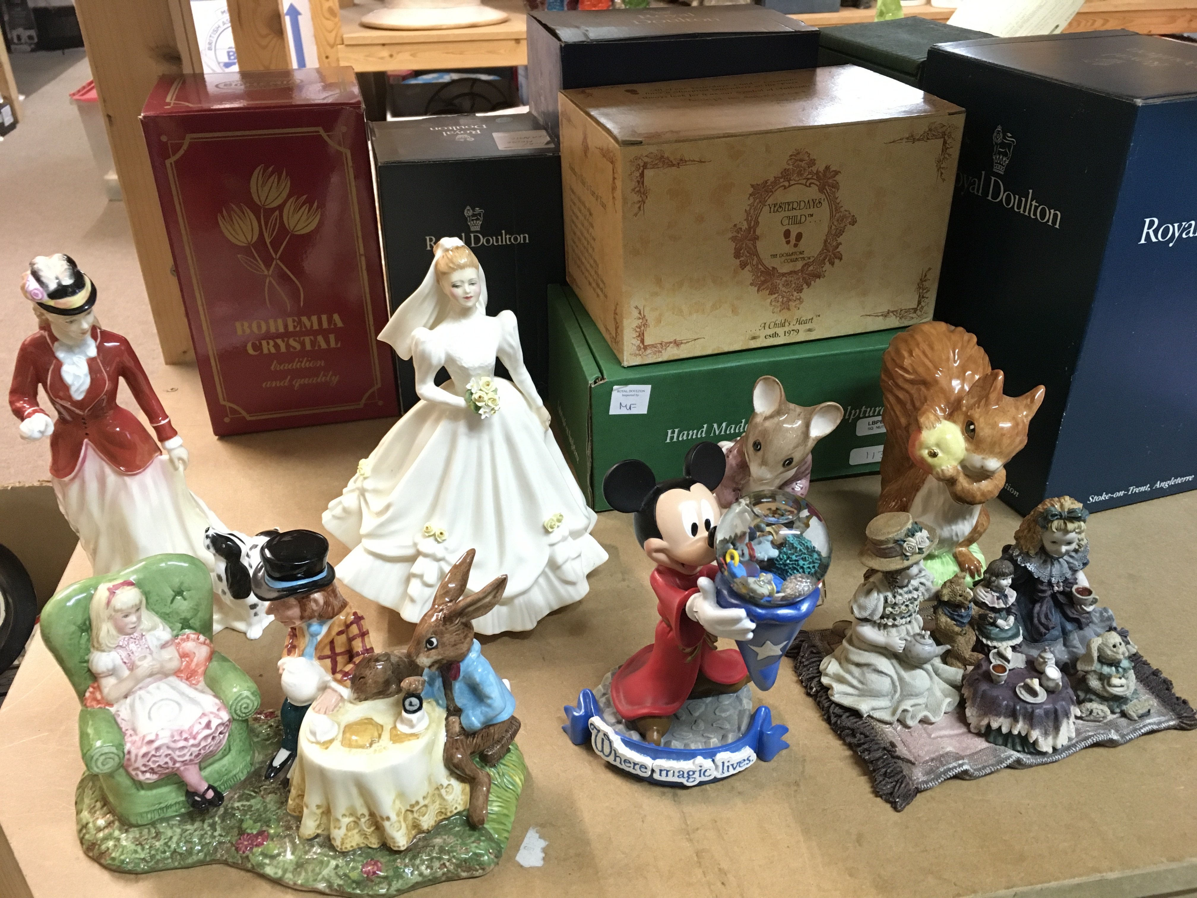A collection of porcelain and other figures including Doulton , Disney , The Boyds, Beswick figures etc. this lot cannot be posted