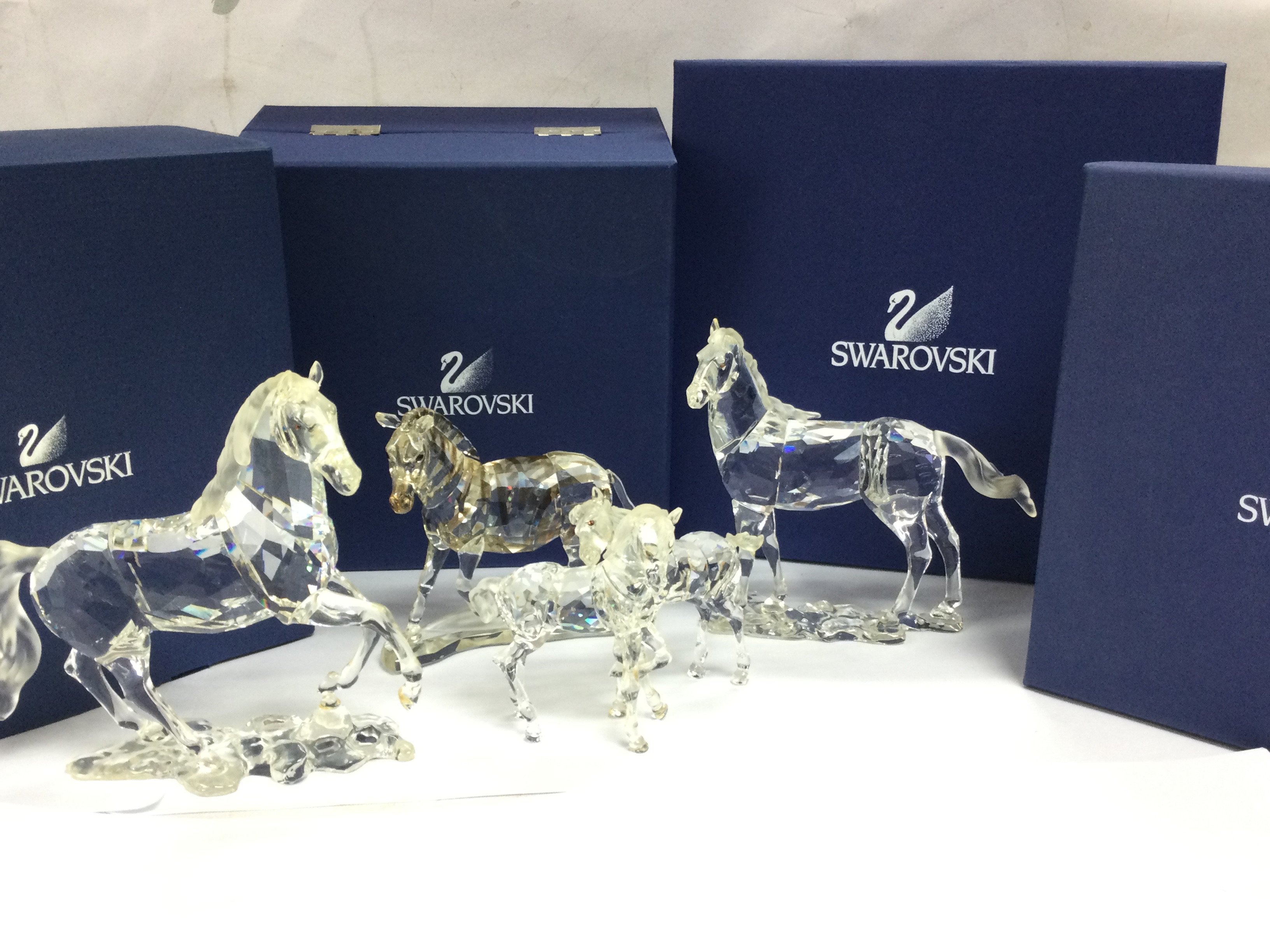 Boxed Swarovski crystal glass figures including a Pair of Foals, Zebra, Stallion and Mare. This lot cannot be posted