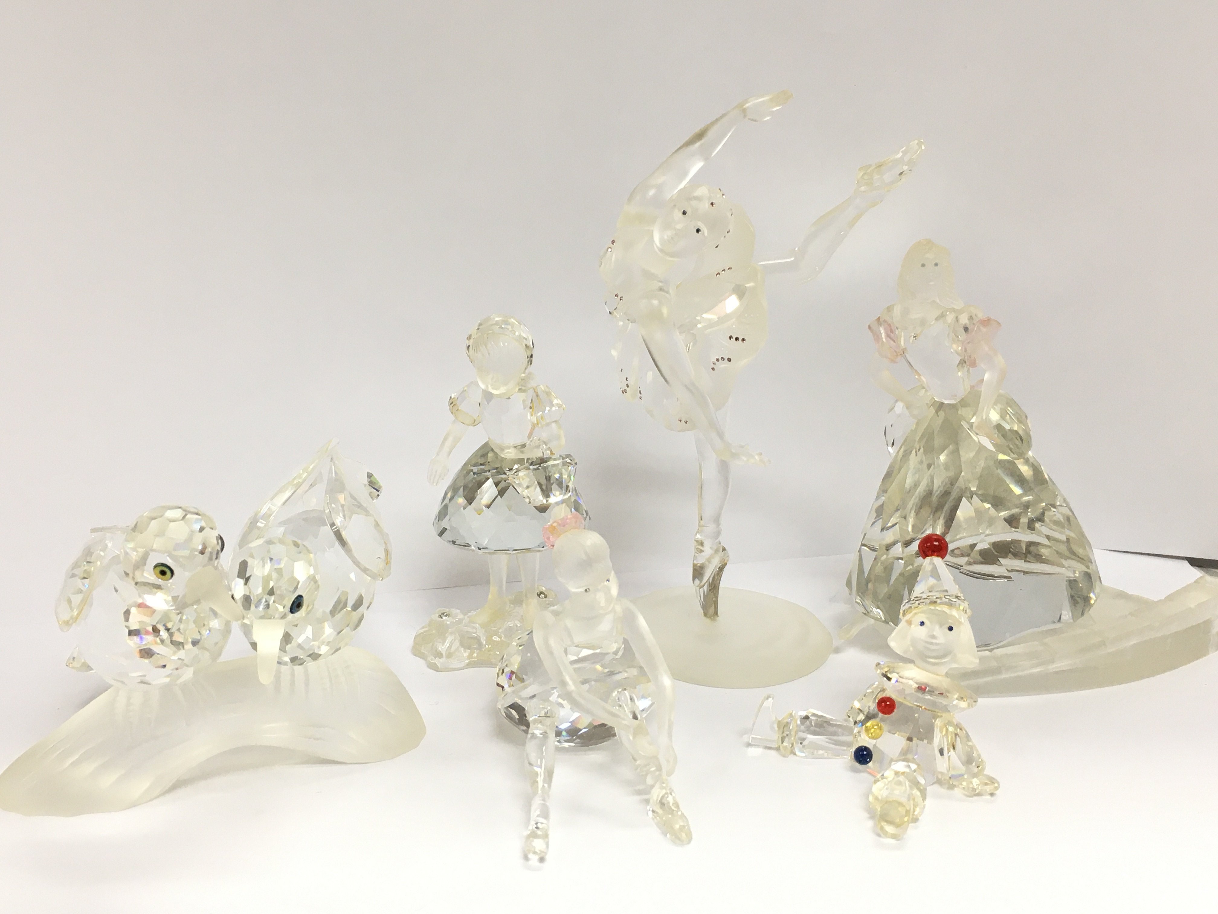 A collection of Swarovski crystal glass figures including Doves, Ballerina, Clown puppet, Cinderella . No boxes. This lot cannot be posted