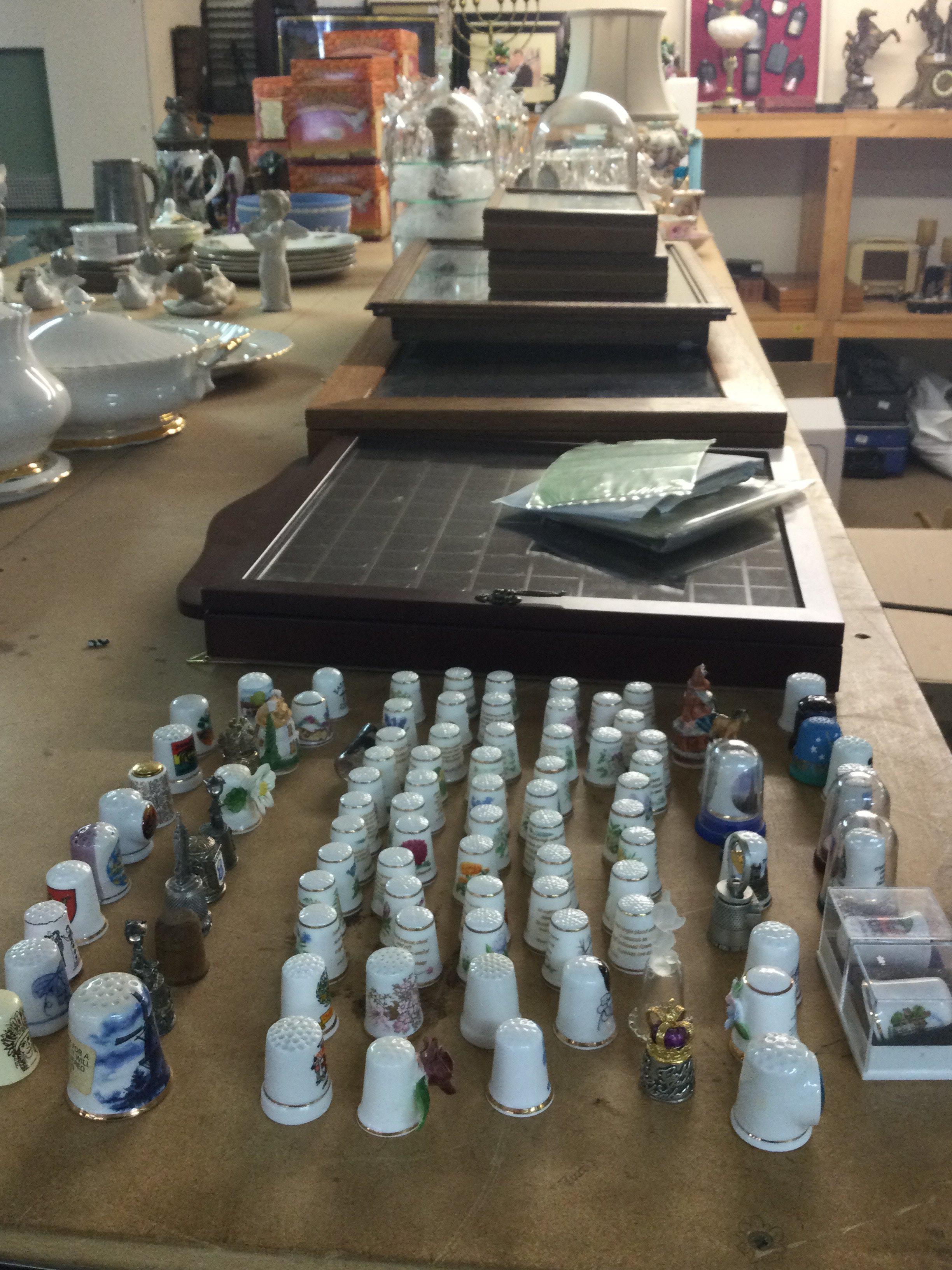 A large collection of ceramic thimbles including five trays, two domes . Approximately 500 thimbles. Including certificates .This lot cannot be posted