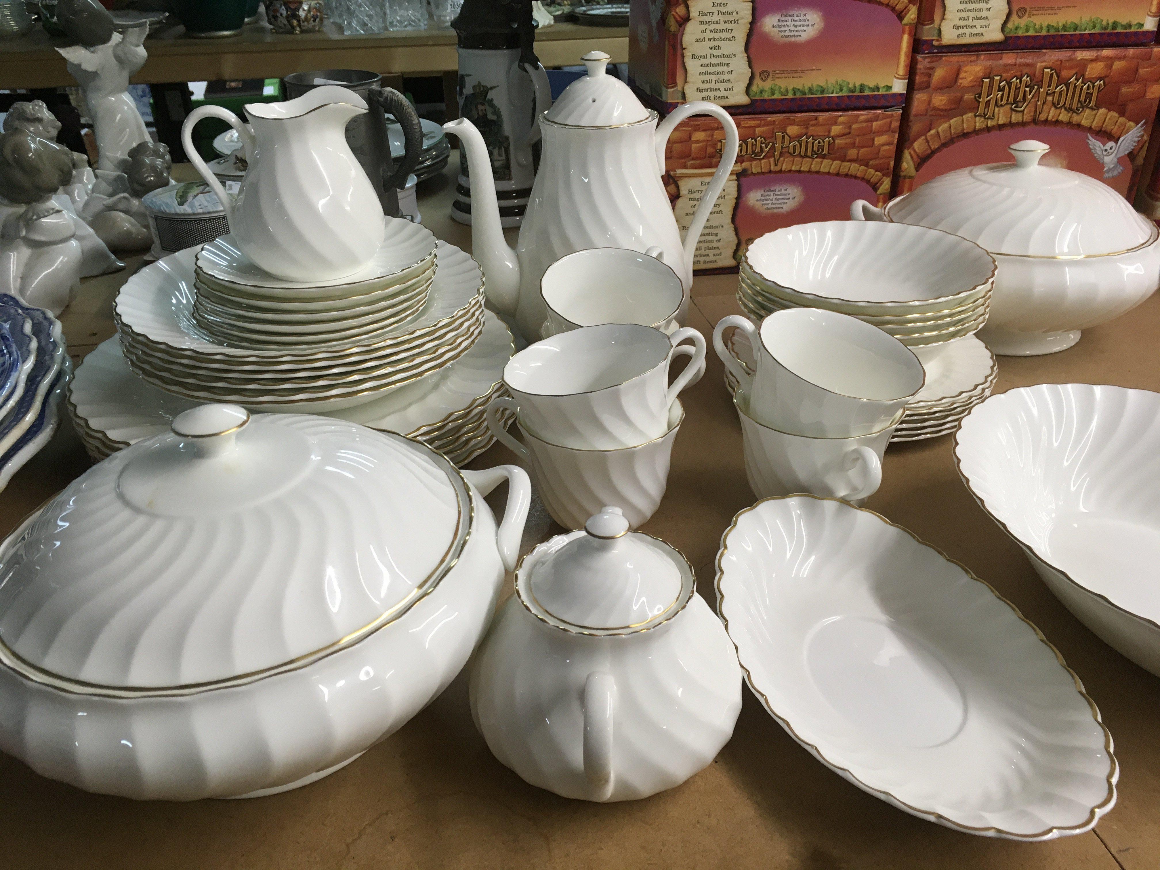 A Wedgwood gold Chelsea service including coffe pot cups saucers and serving dishes.