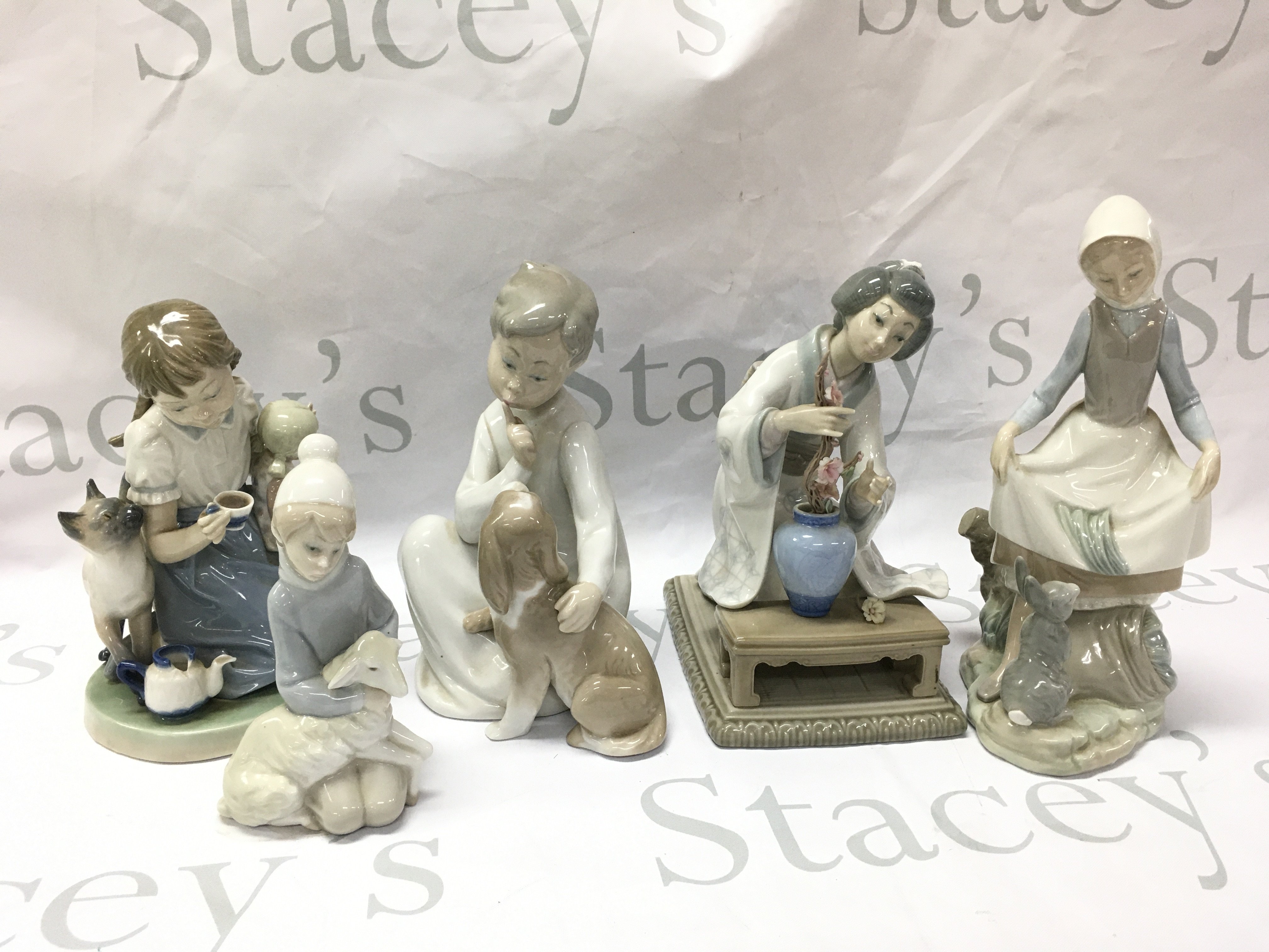 Five Lladro porcelain figures , this lot cannot be posted