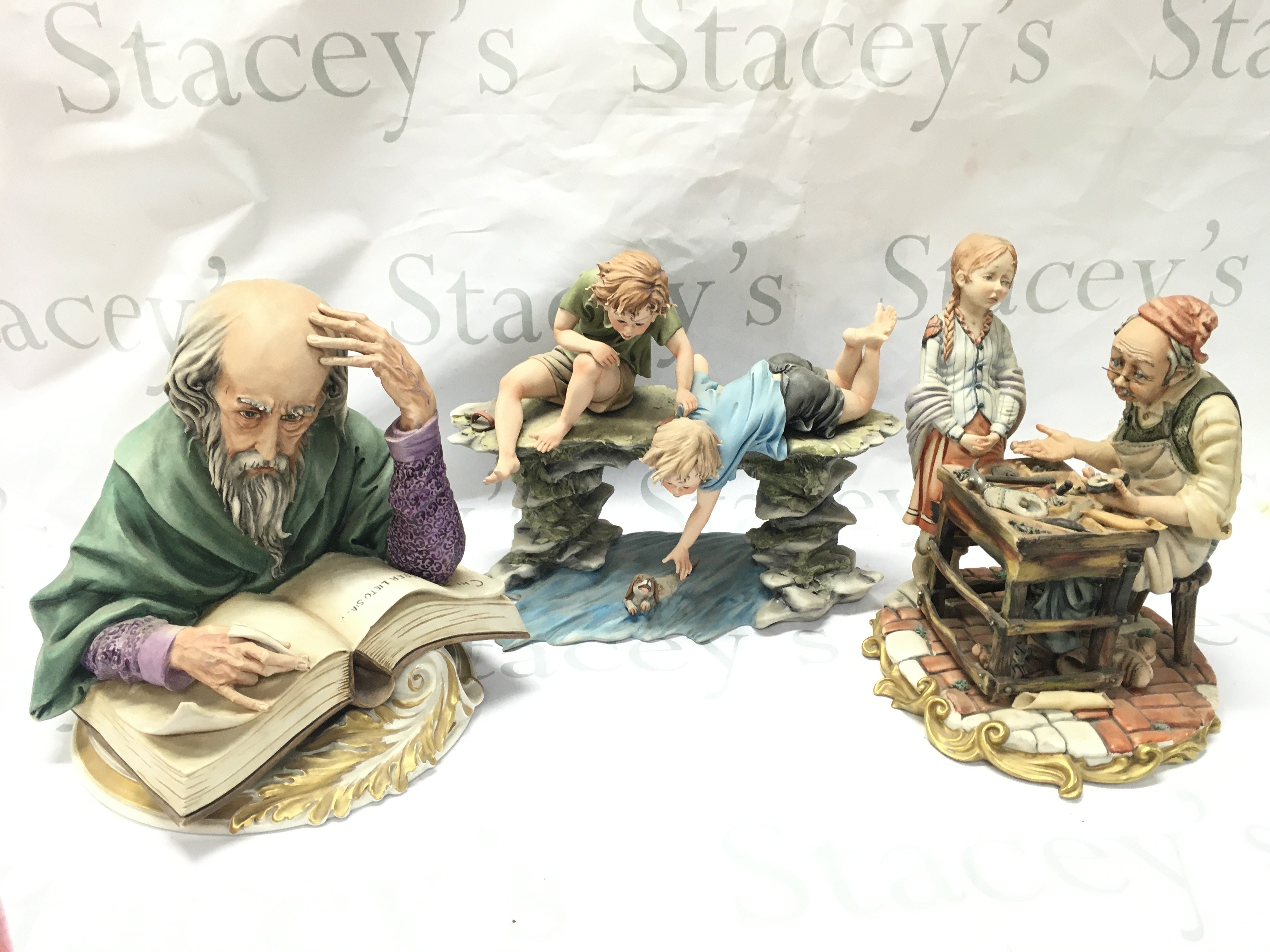 Capodimonte figures including the writer, Cobbler, boys Saving dog. Tallest 24cm tall. This lot cannot be posted