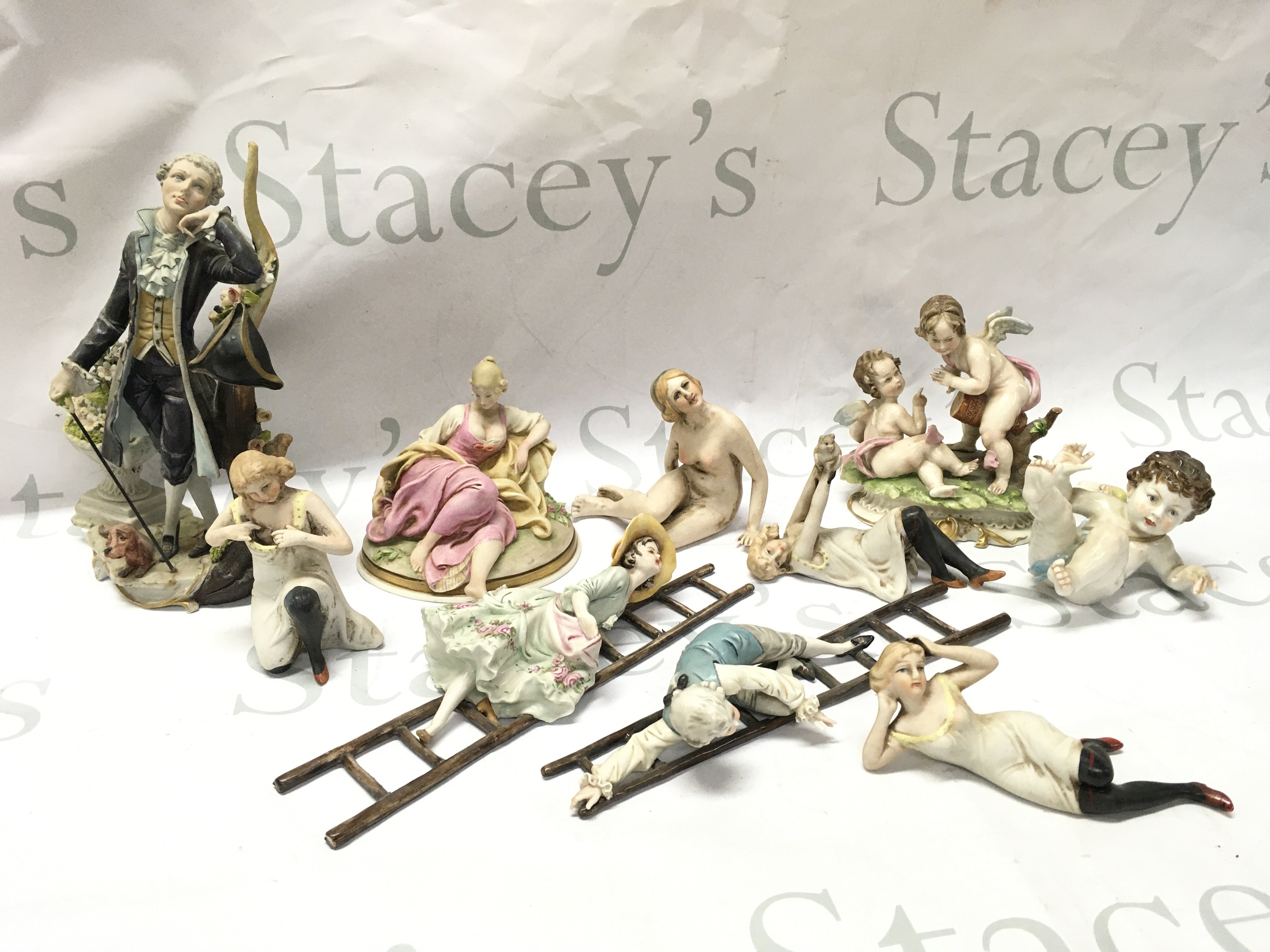Capodimonte bisque figures including Capodimonte marked ladder couple, cherub and cherub figure group. This lot cannot be posted