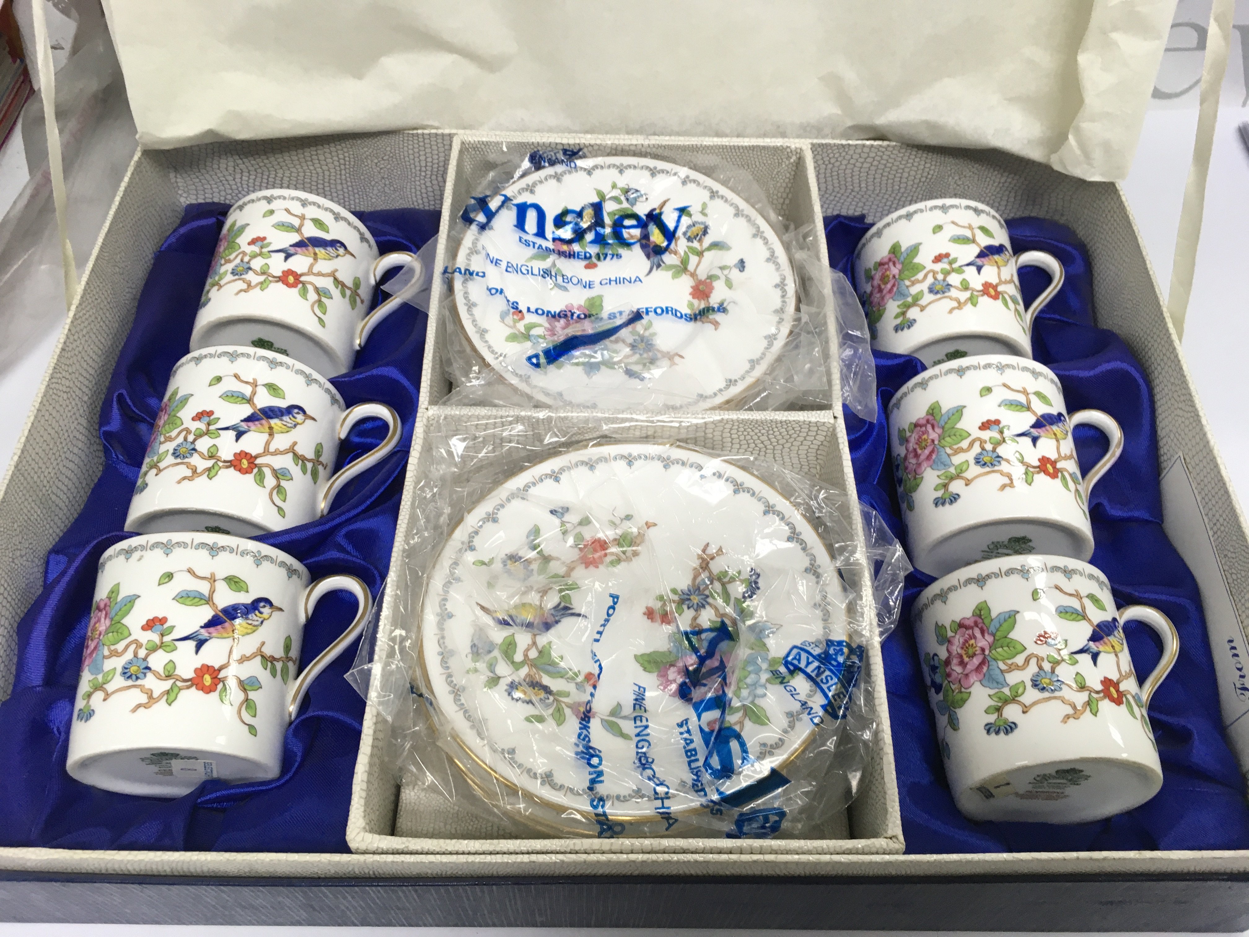 A boxed Aynsley coffee set in Pembroke pattern. Shipping category D.