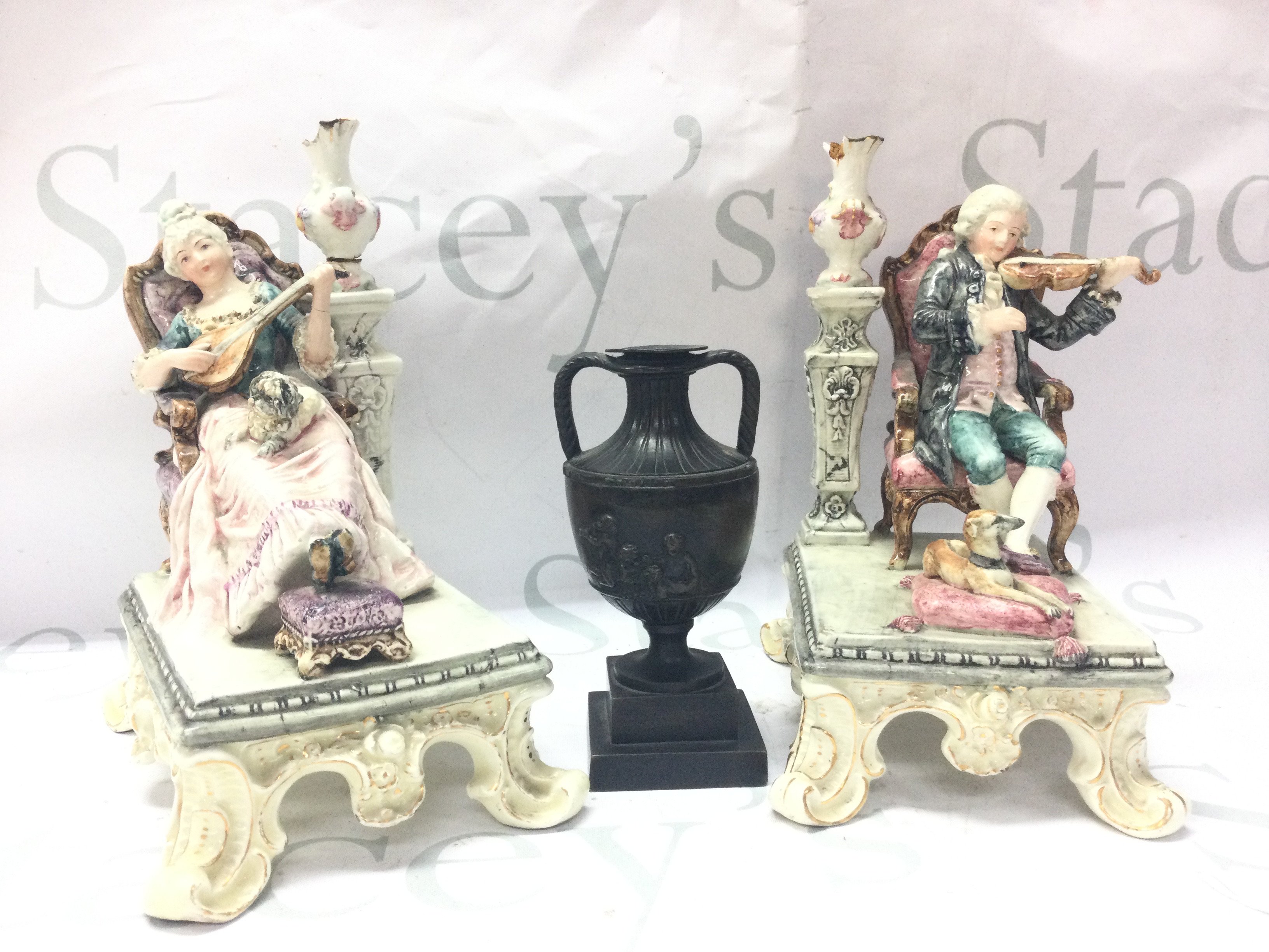 A pair of classical style seated couple figures (20cm tall approx. Damaged and restored )and a late 19th century bronze twin handled vase with putti scene decoration, 13cm tall. This lot cannot be posted