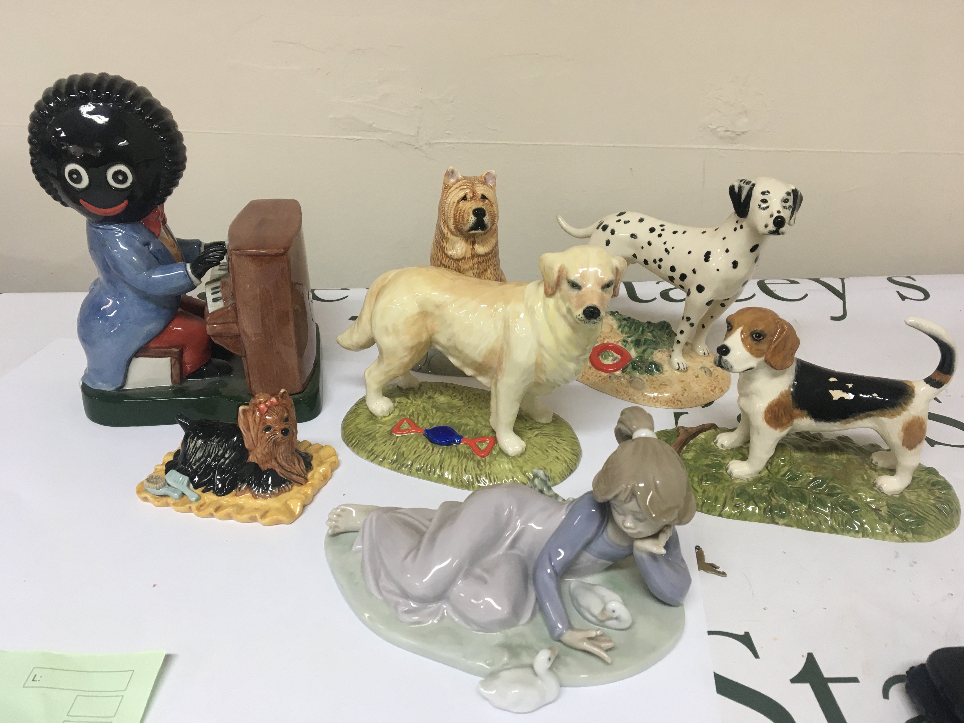 A Lladro figure Royal Doulton animal figures a Carlton Golly figure (damaged)