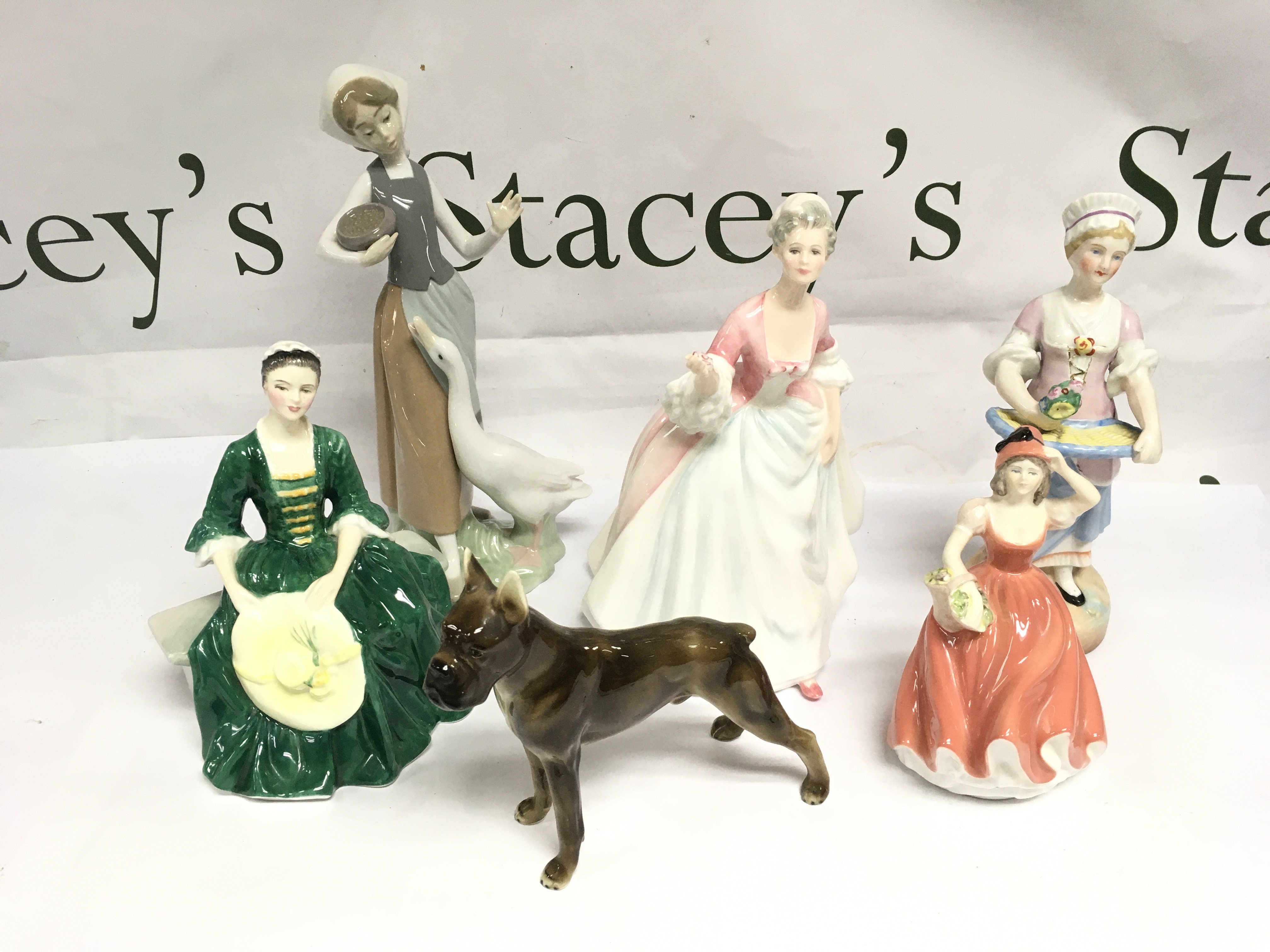 A collection of ceramics and boxed crystal comprising various Royal Doulton figures, a boxed Lladro figure, Edinburgh crystal decanter etc. Shipping category D.