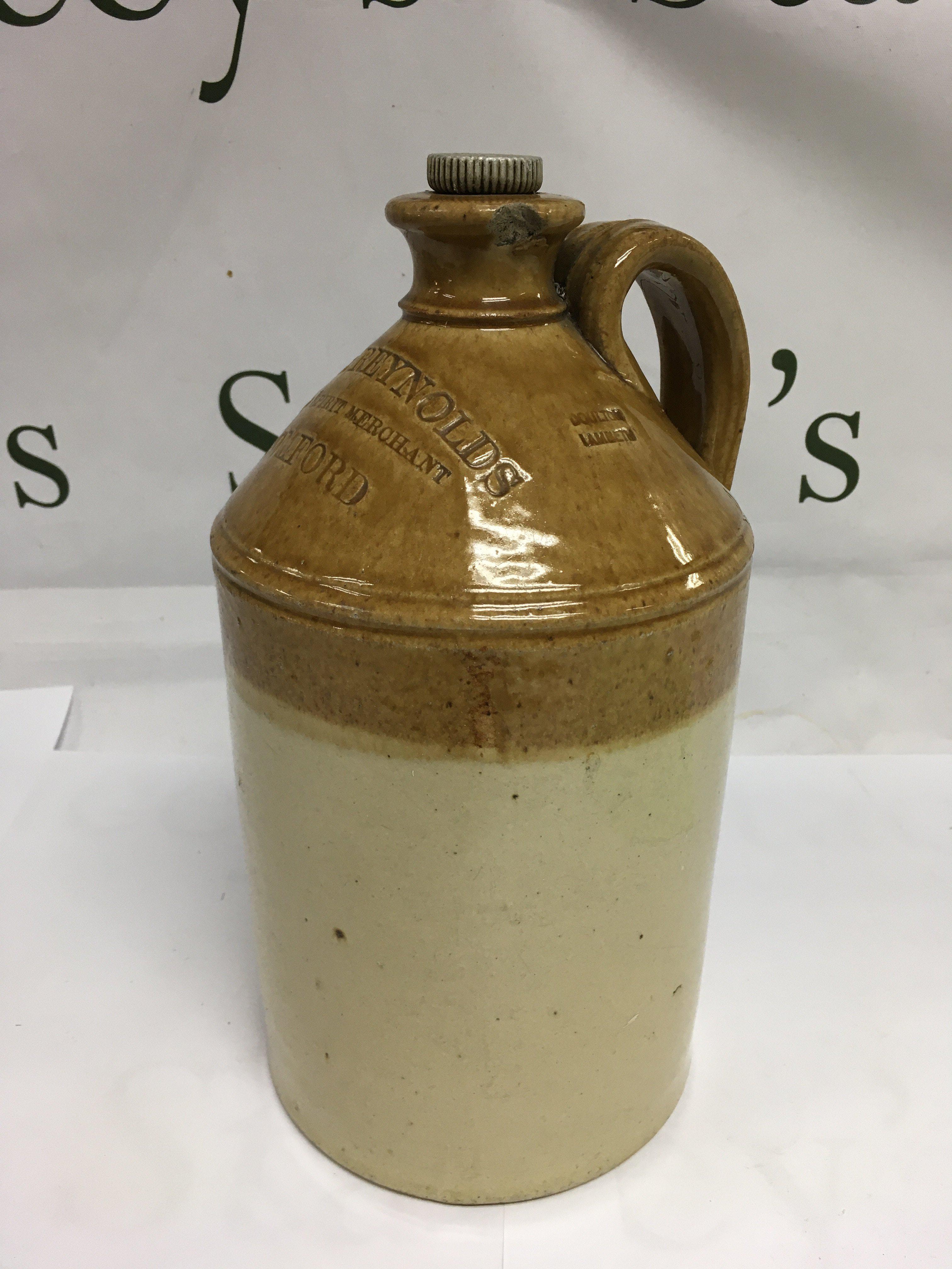 A Doulton Lambeth stoneware bottle marked Peter Reynolds Wine & Spirit Merchant, Romford. Shipping category D.