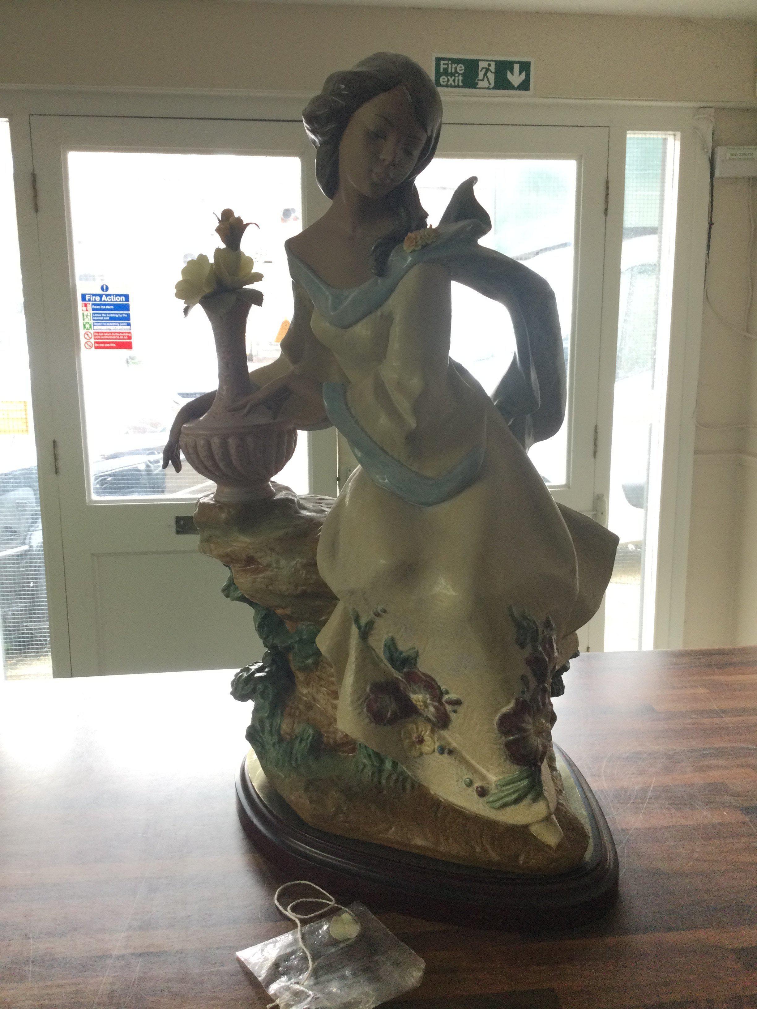 A Lladro Garden Breeze Gres figure, issued 2001 retired 2003. Lladro number 3583. Limited Edition of 1500. Flower petal needs re gluing. No other obvious damage or restoration. Including base 59cm tall. This lot cannot be posted