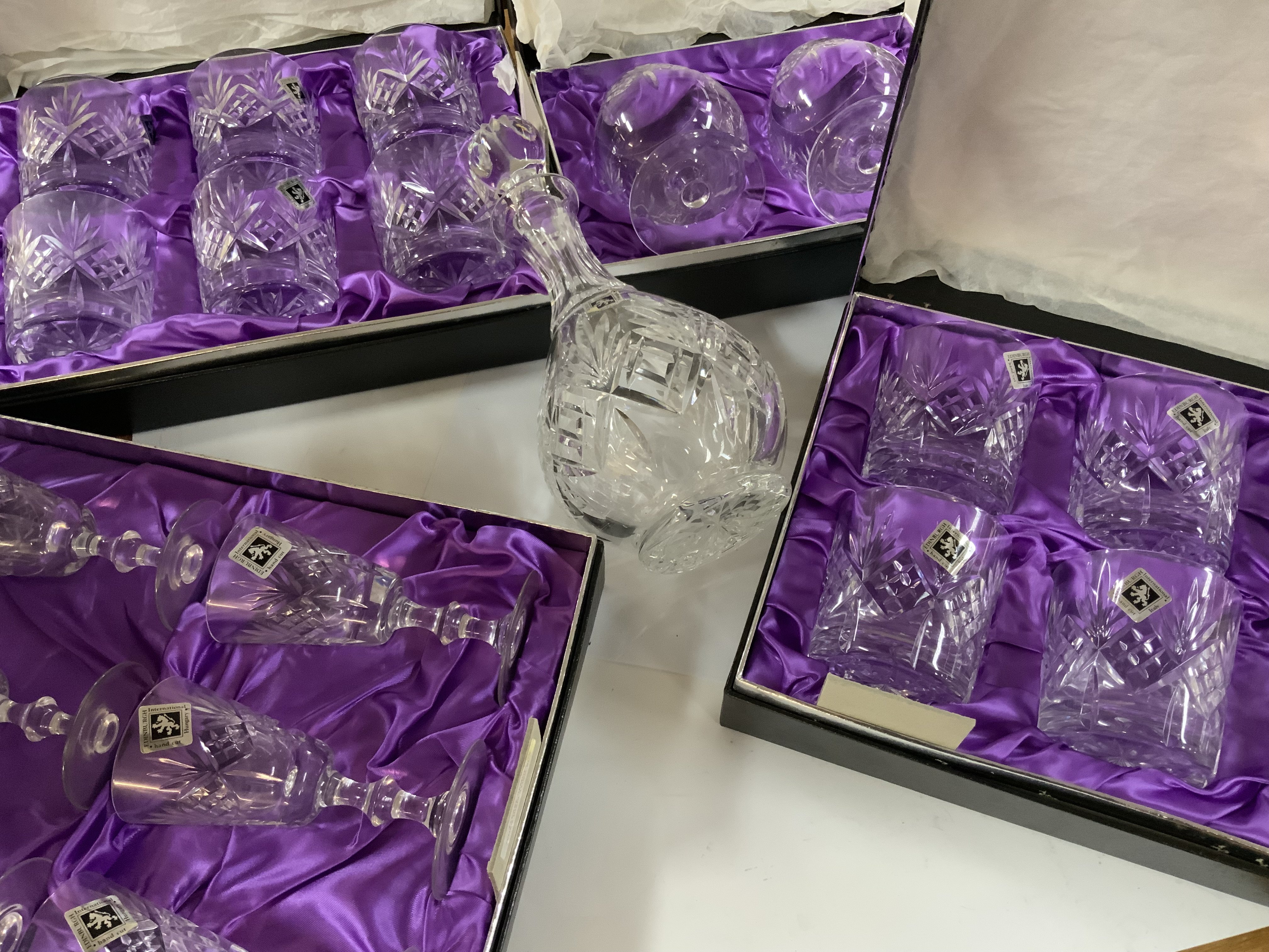 5 boxed Edinburgh crystal glass sets and a matching decanter.