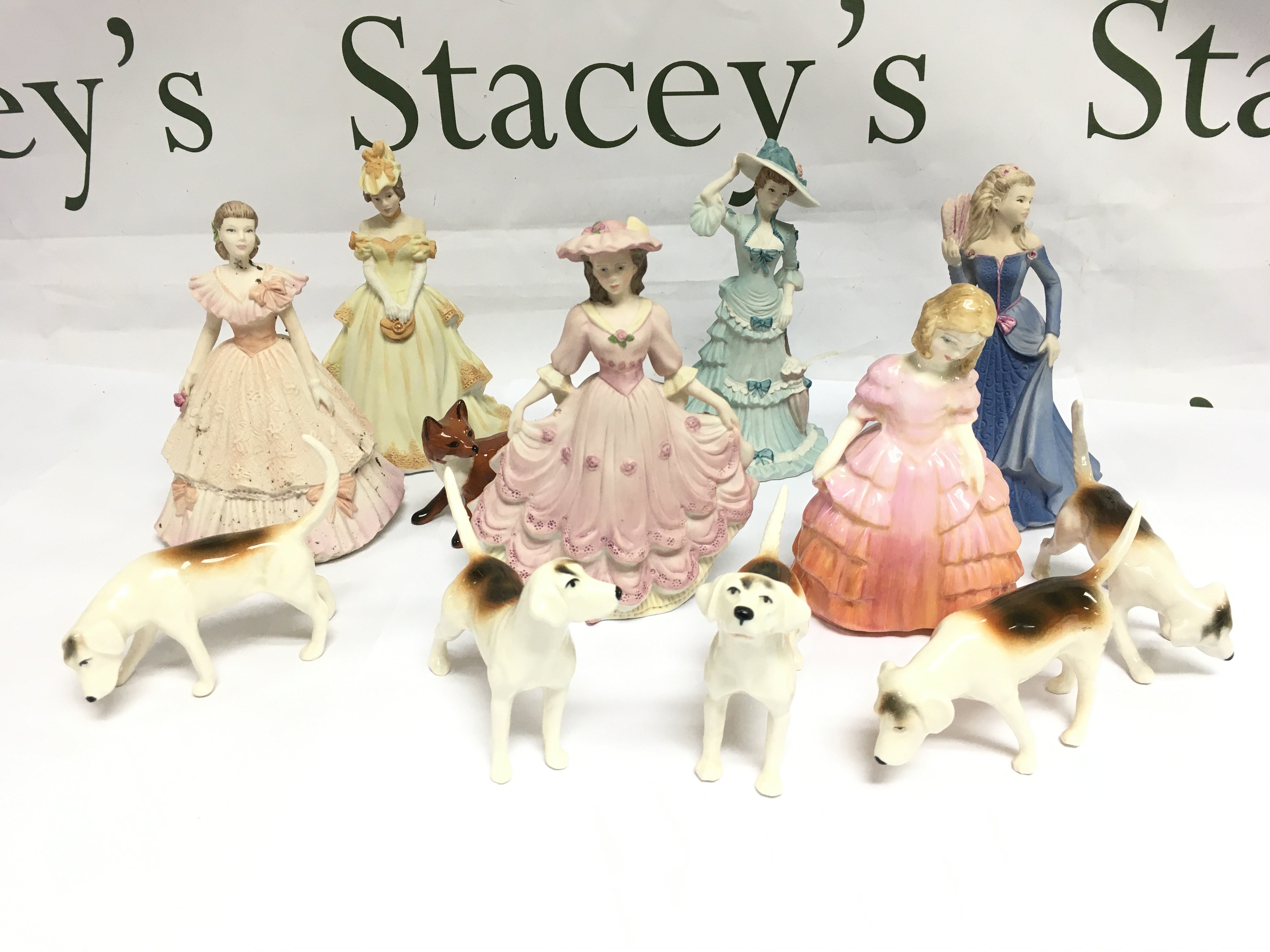 A collection of ceramic figures comprising Royal Doulton, Beswick and Coalport examples. Shipping category D.