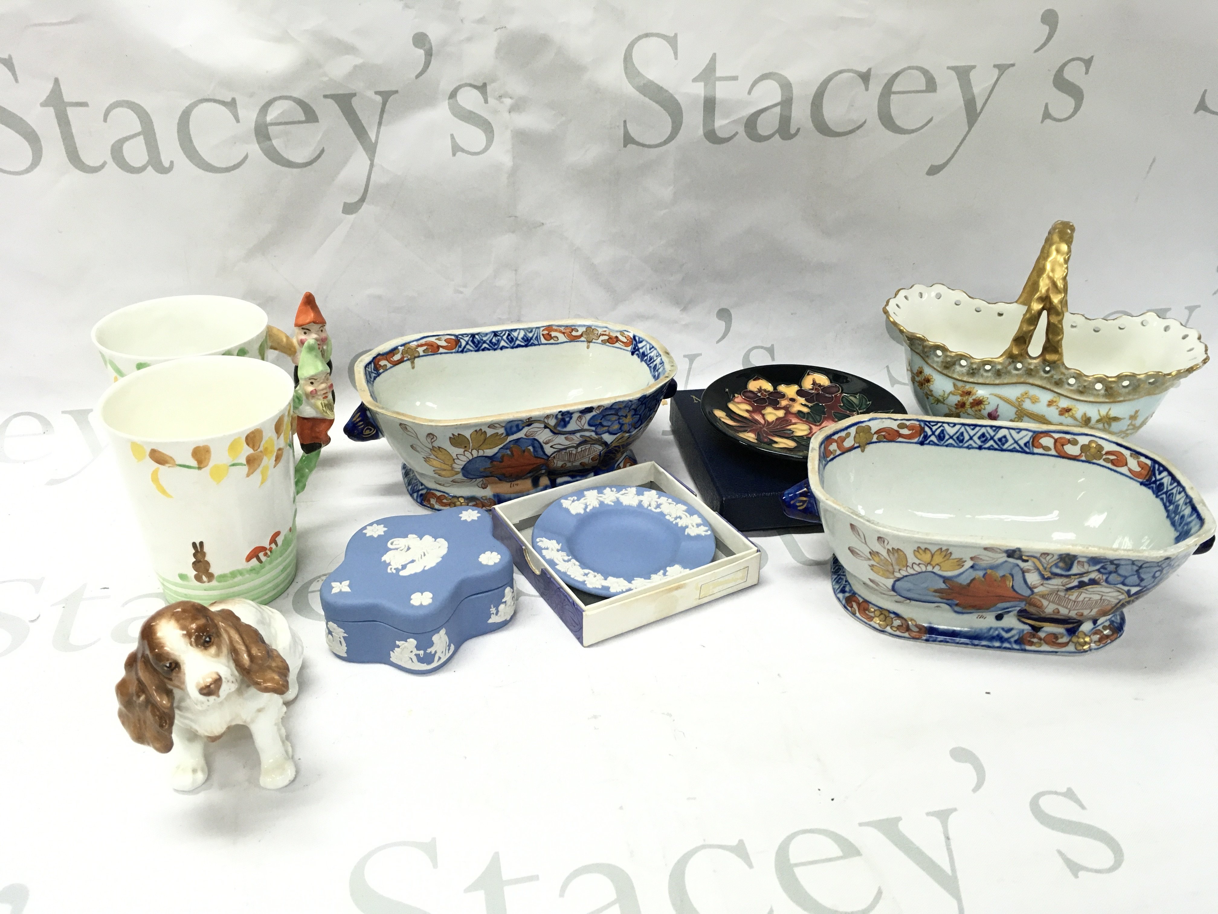A Collection of various ceramics including a British made cocker spaniel figure , Wedgwood box and dish, Moorcroft boxed dish, Wellington pixie mugs, Imari design tureens . This lot cannot be posted