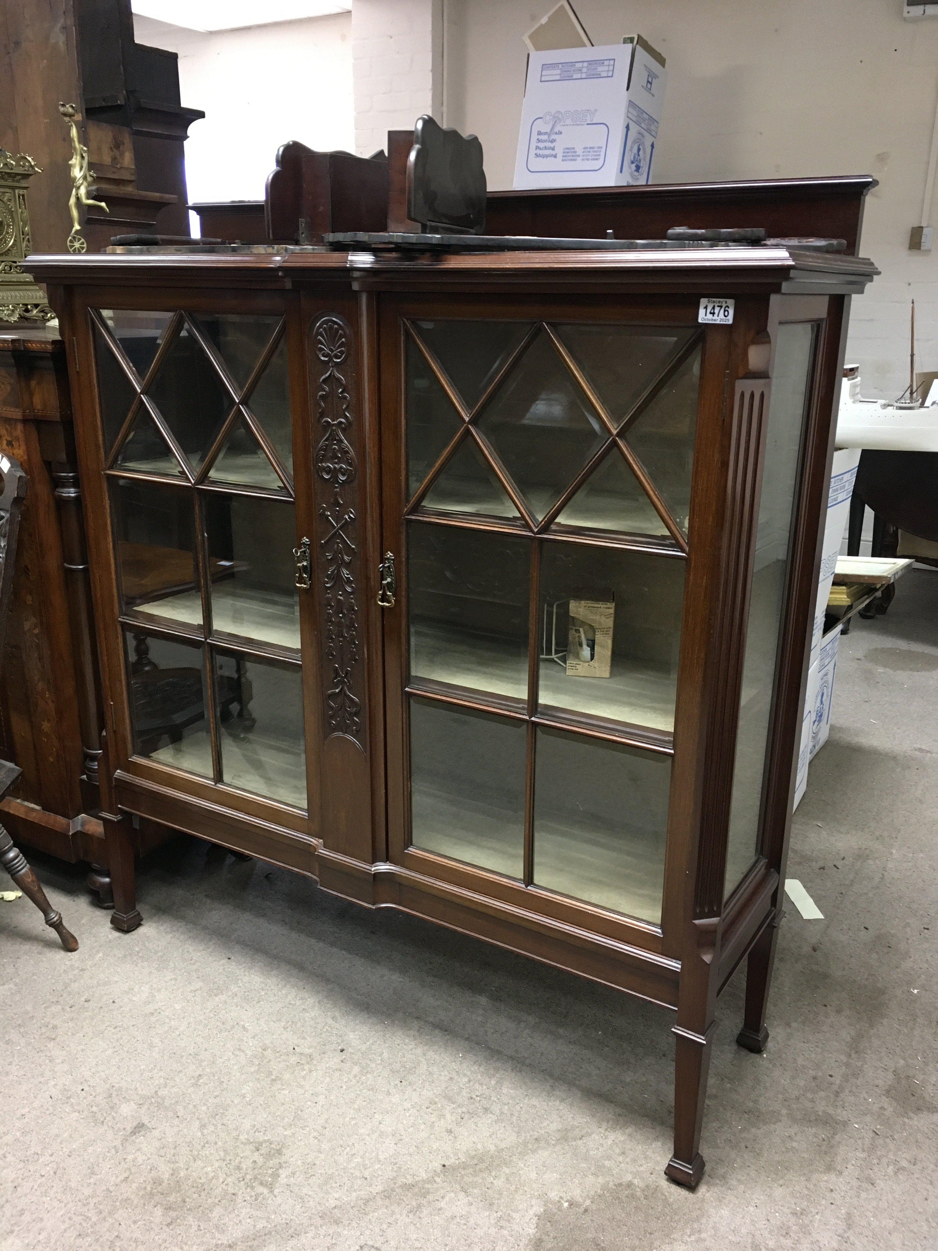 An Edwardian mahogany display cabinet with a pair of glazed doors inclosing shelves on square tapering legs. 130cm x 122cm x 40cm. NO RESERVE