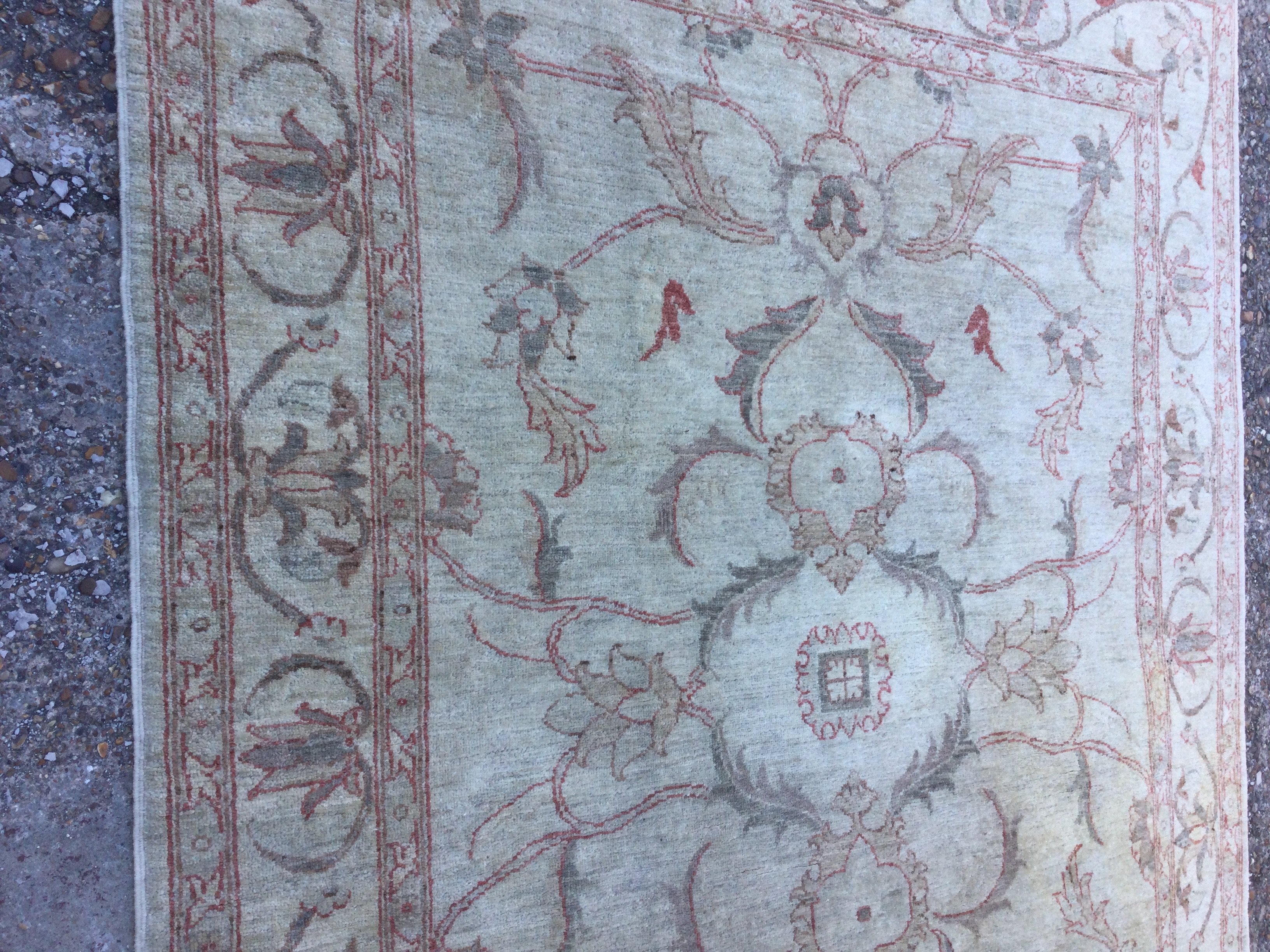 A Afghan rug with floral design on ivory field. 210 cm x 150 cm- NO RESERVE