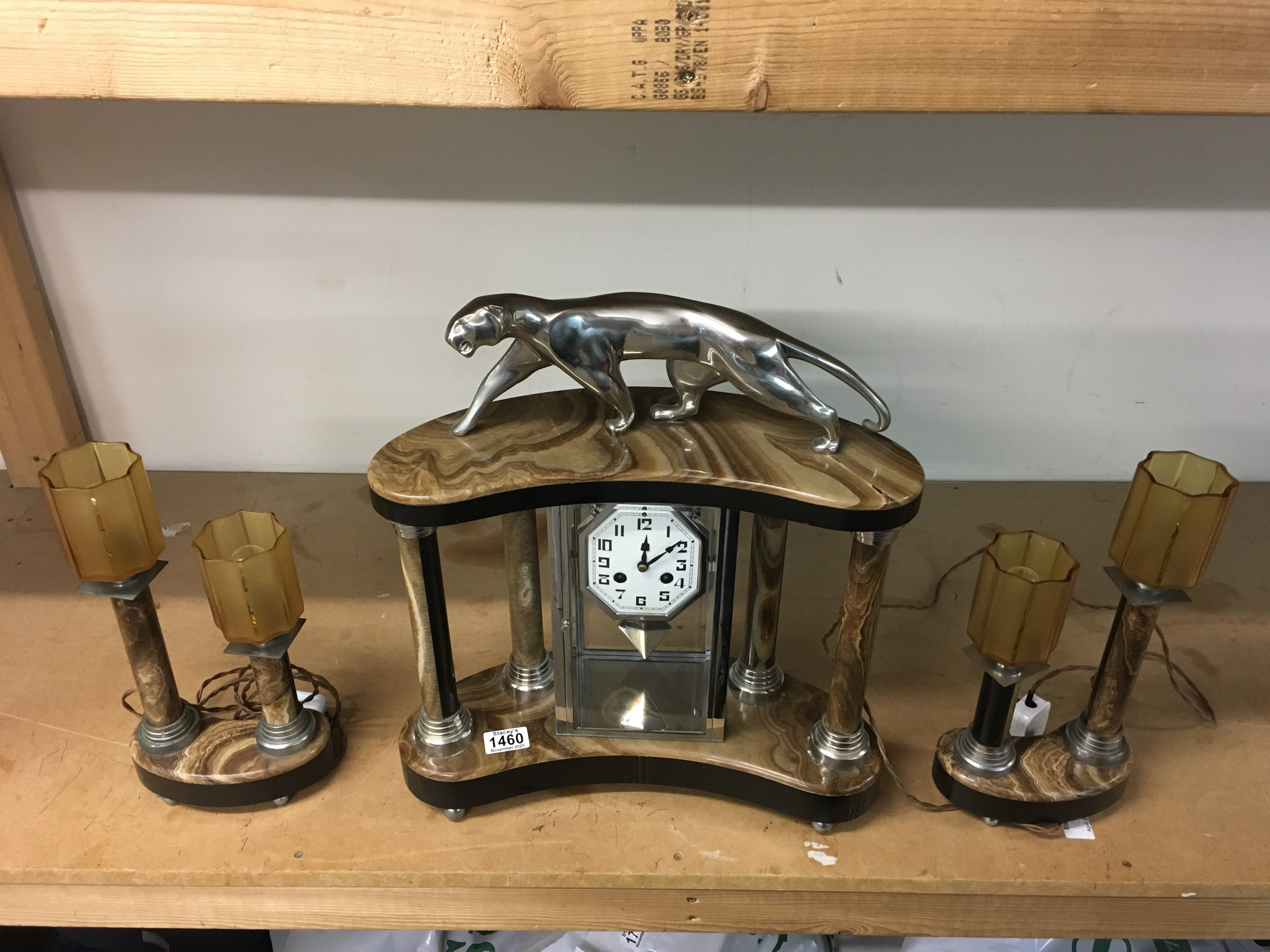 An art deco style marble panther clock with garnitures.