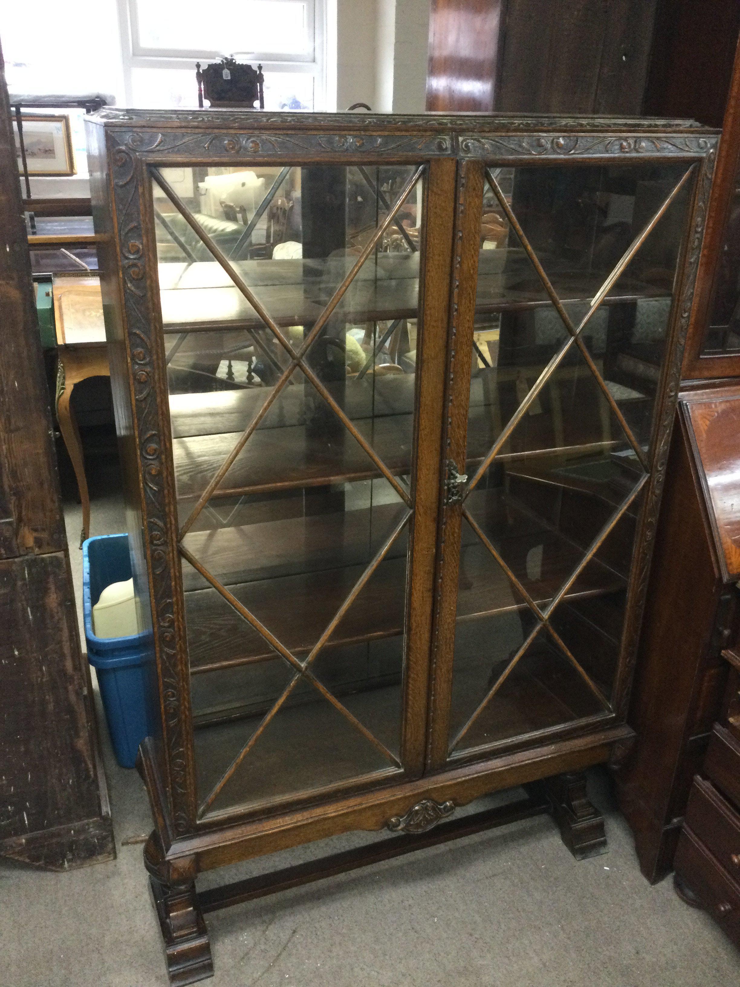 An Oak mid 20th century astral glazed cabinet with key . Dimensions 92cm wide 150cm tall 30cm deep