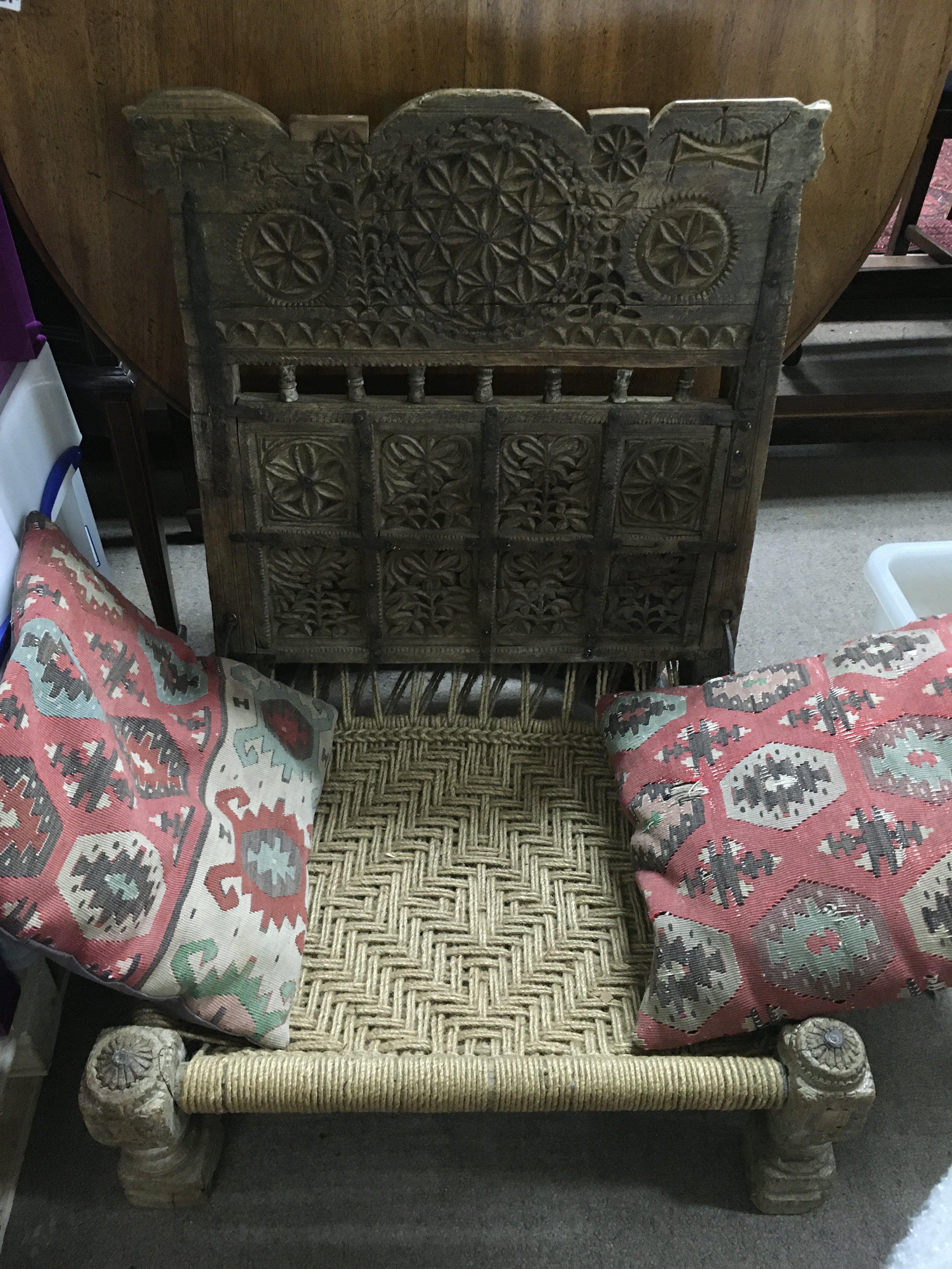 An antique Indian carved chair. Shipping category D.