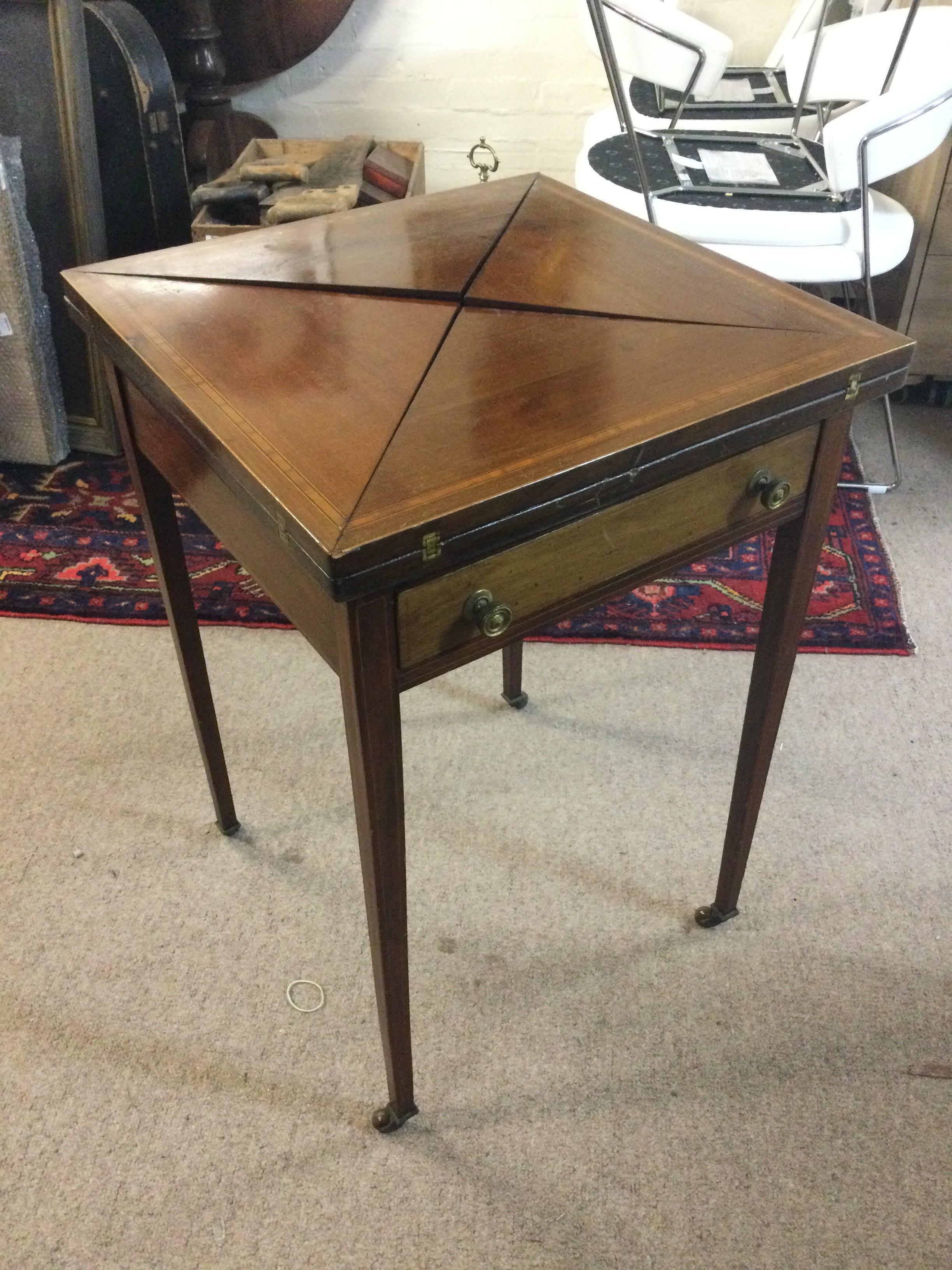 An Edwardian envelope card table , dimensions 72cm tall . Extended top length and width 73x73cm closed 52x52cm approximately .
