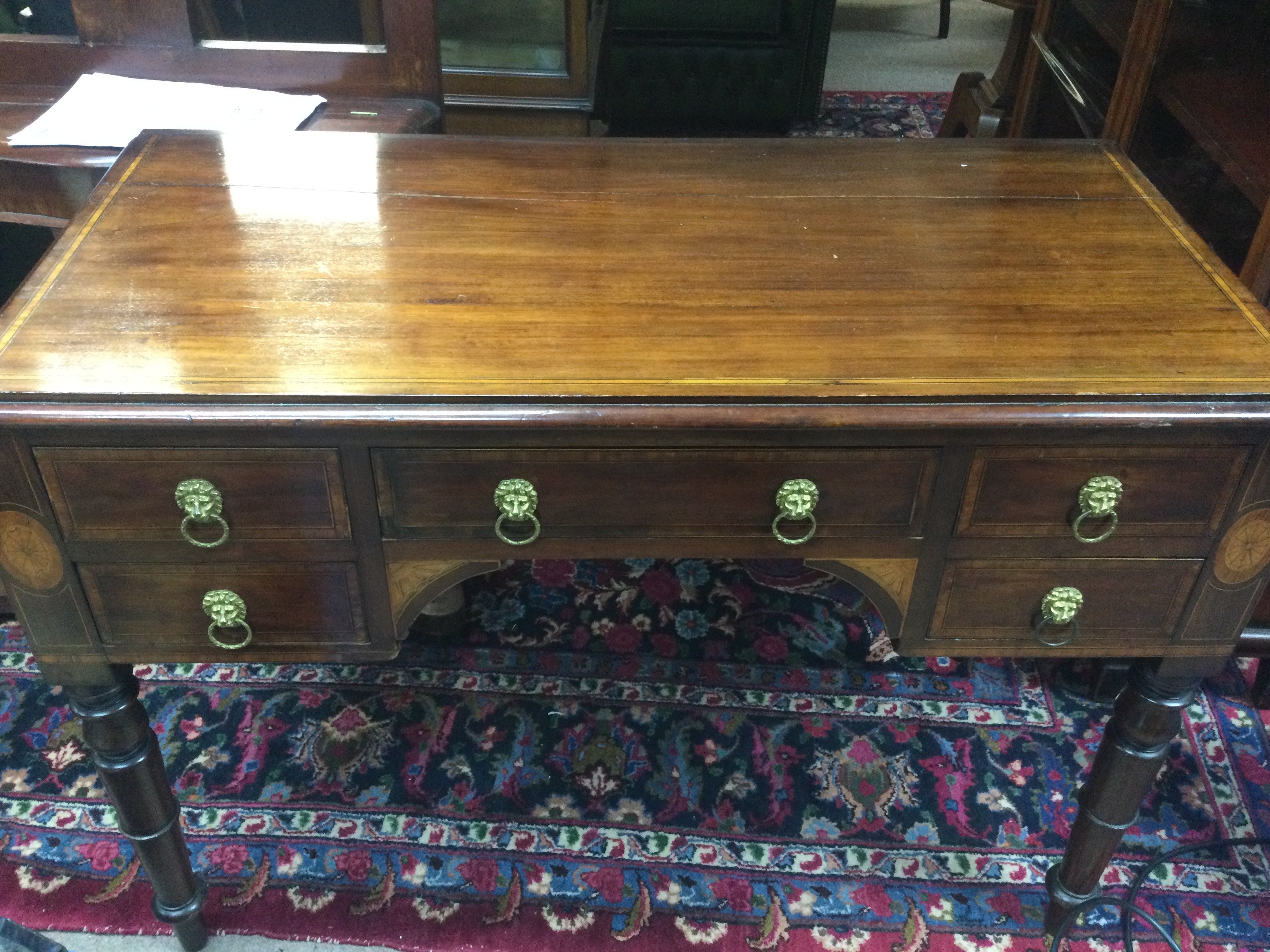 An inlaid mahogany desk fitted with drawers on turned legs , dimensions 104cm wide 50cm deep 75cm tall