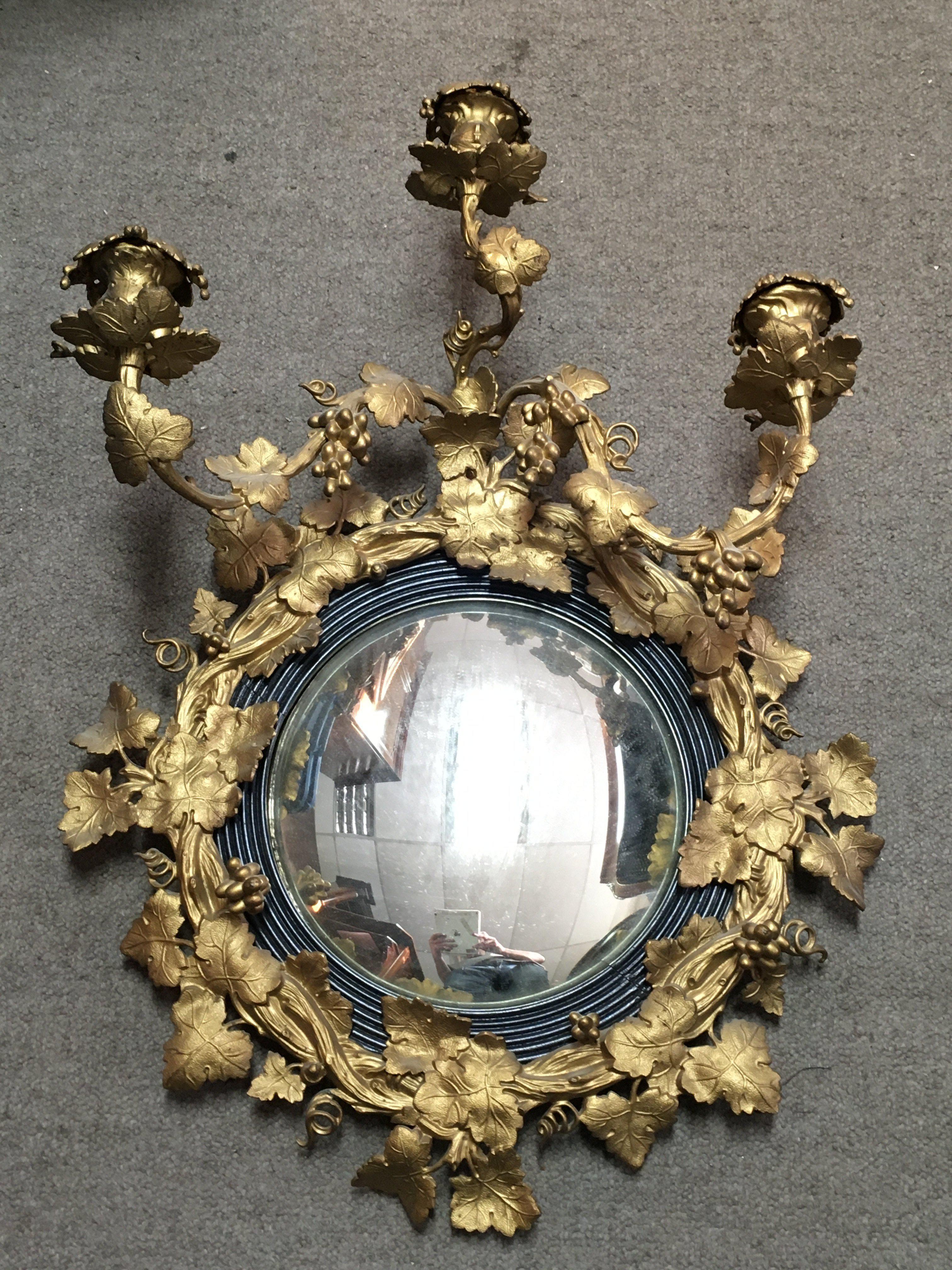 A quality 19th century gilt metal girandole wall mirror with a frame featuring twisted branches, leaves and grapes. 49cm wide. This lot cannot be posted