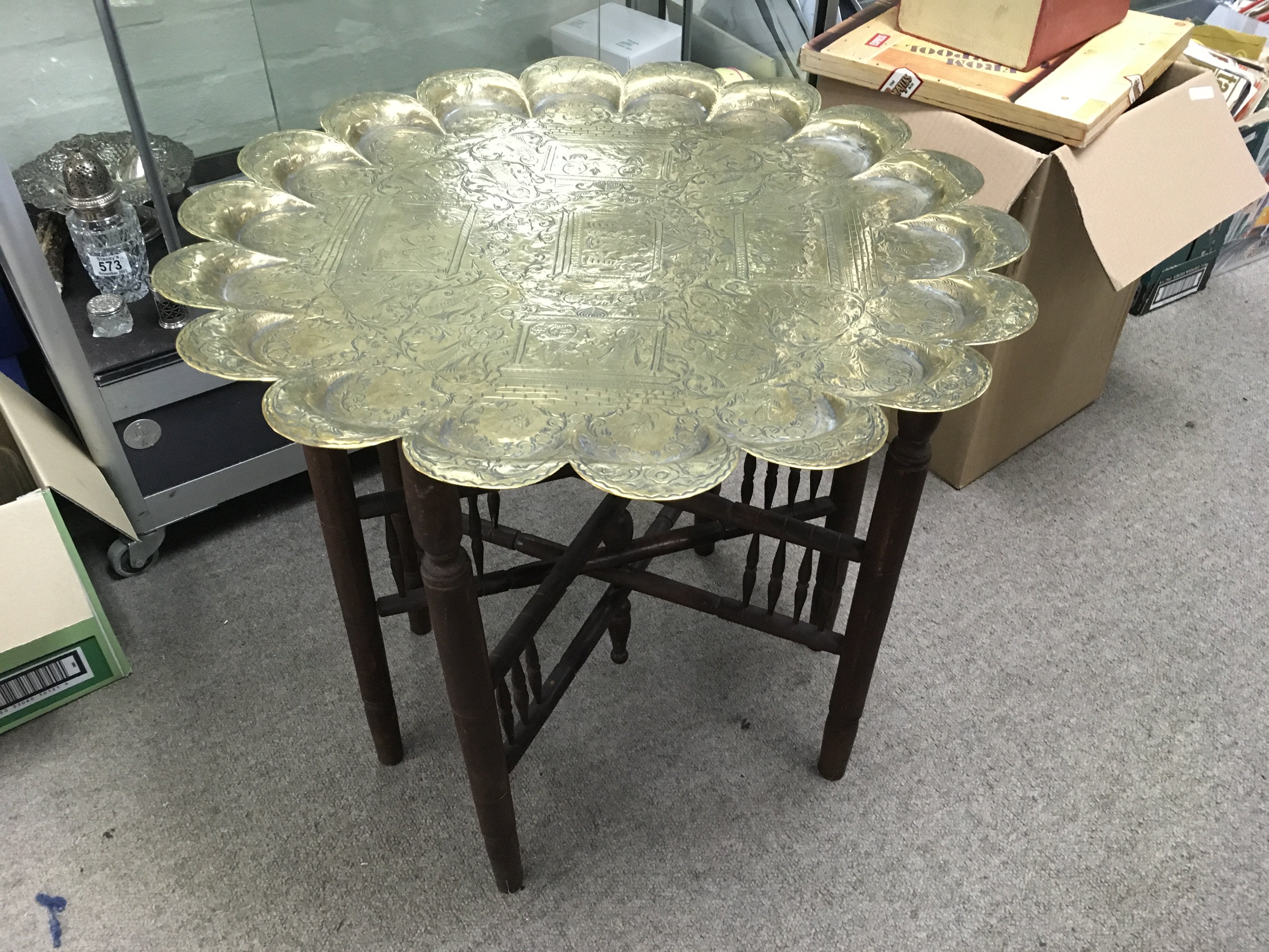 A brass top occasional table, approx diameter 60cm. Shipping category D.