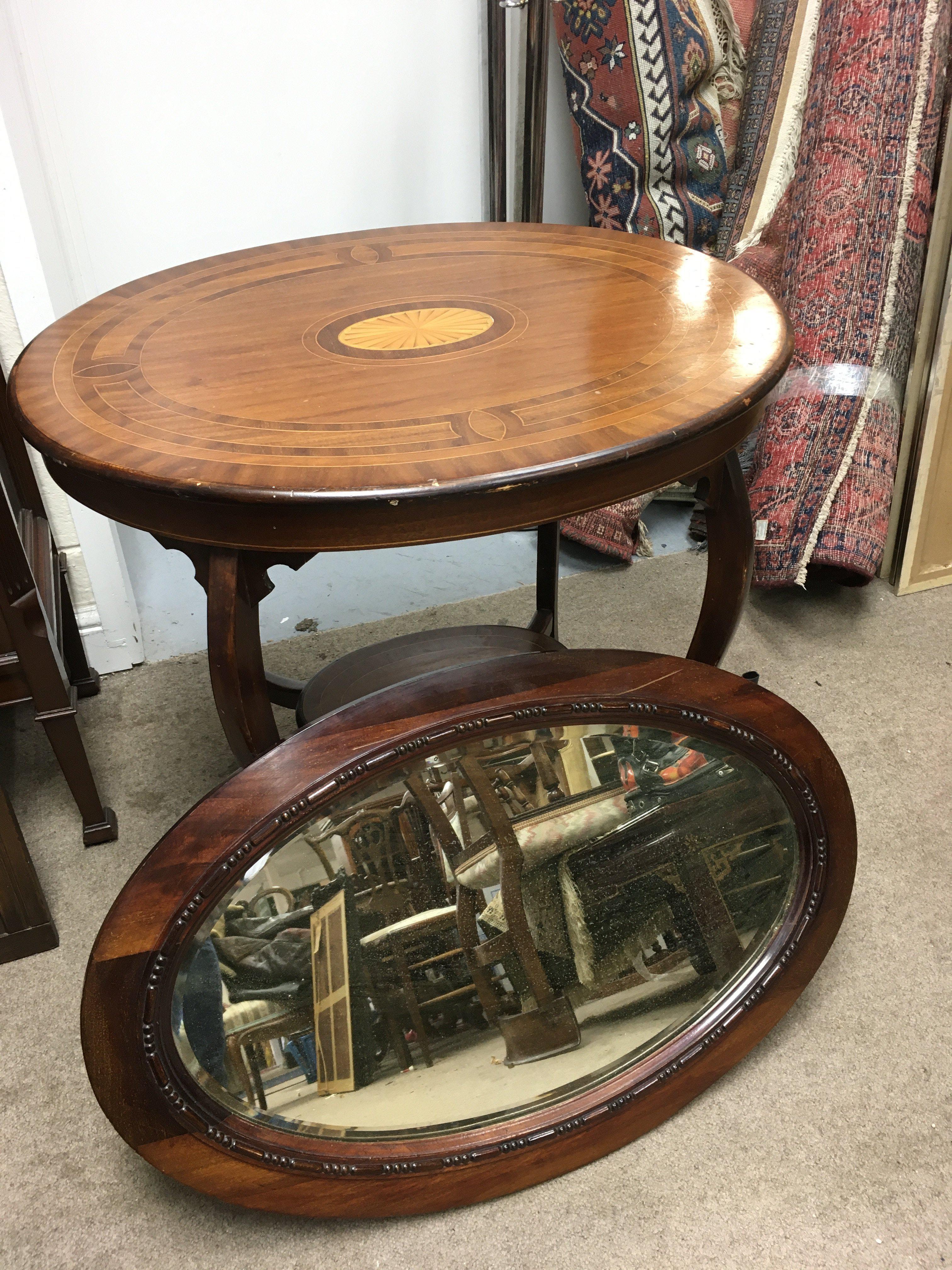 An Edwardian inlaid mahogany table, approx diameter 76cm and a mahogany framed wall mirror (2).