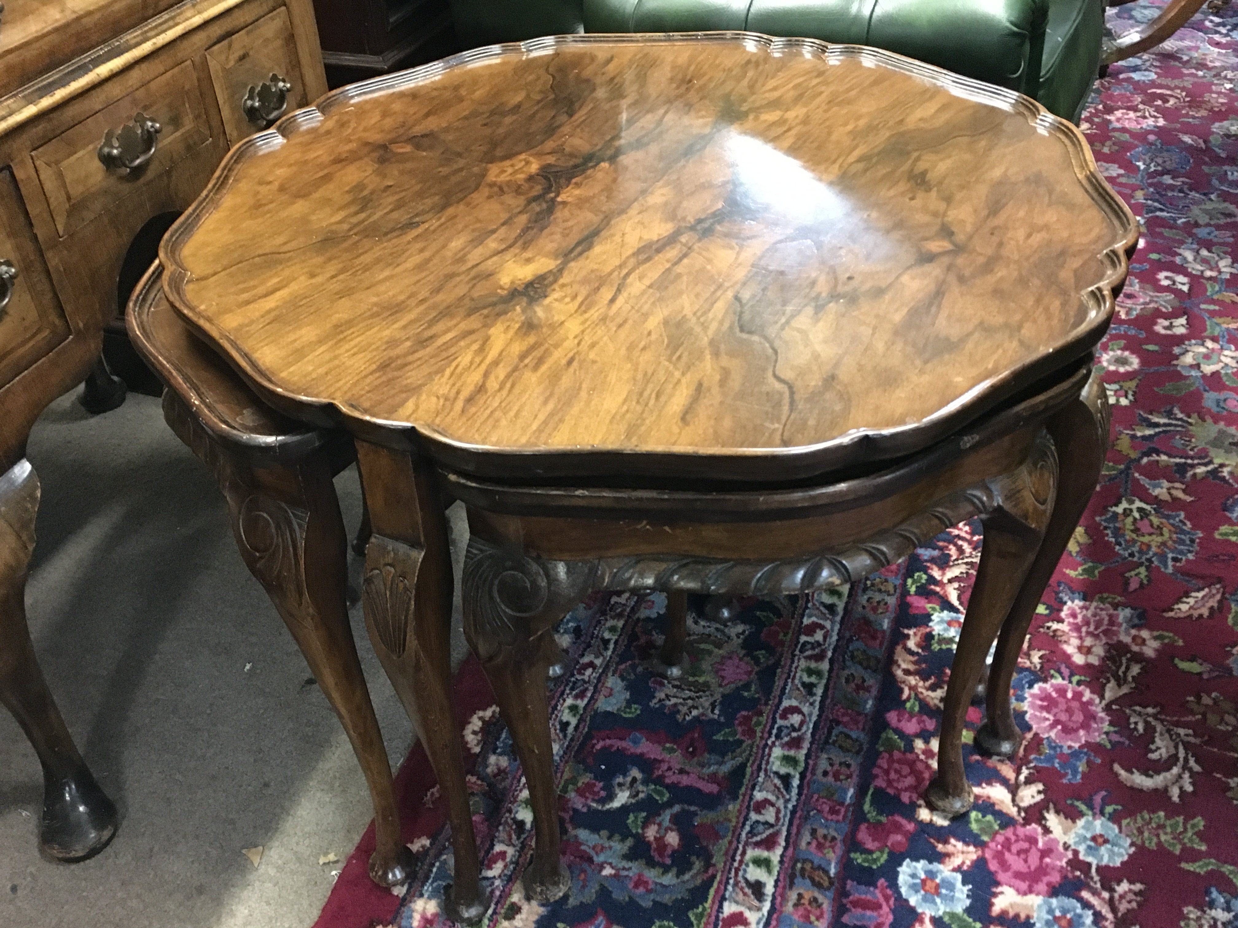A nest of walnut tables , dimensions 75cm wide 52cm tall