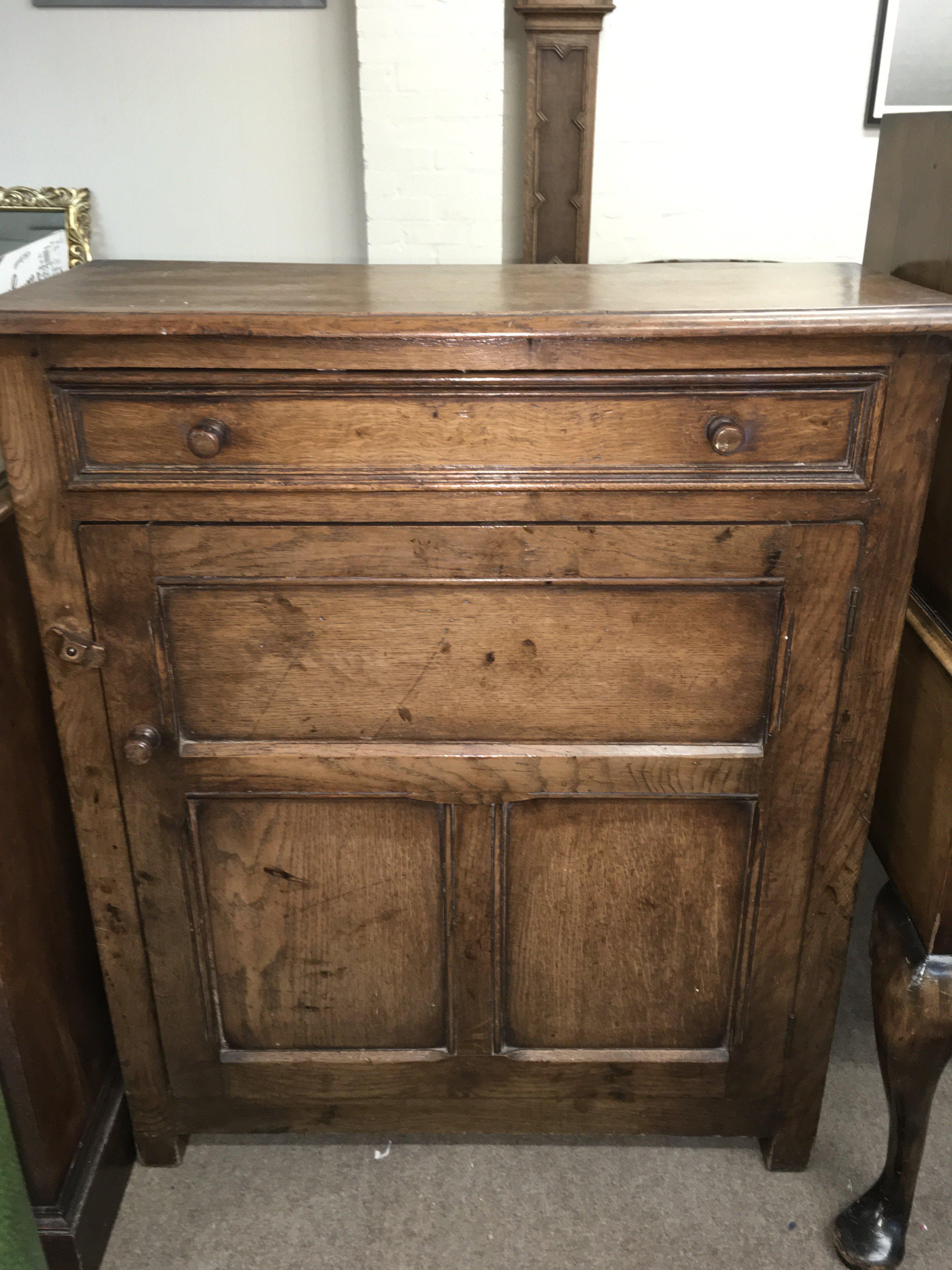 A carved oak side table with a single drawer, dimensions 86cm tall 76cm wide 32cm deep