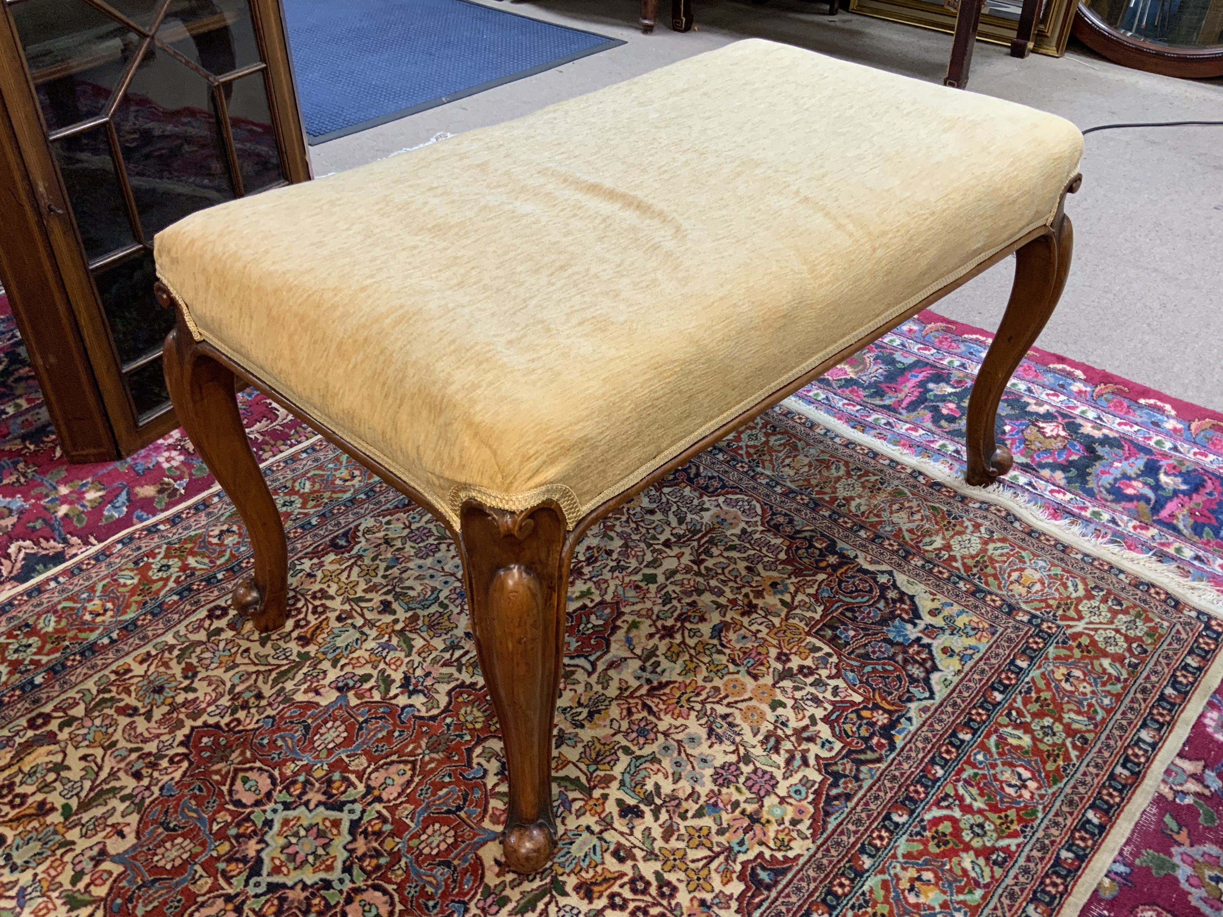 A 20th Century upholstered walnut stool.