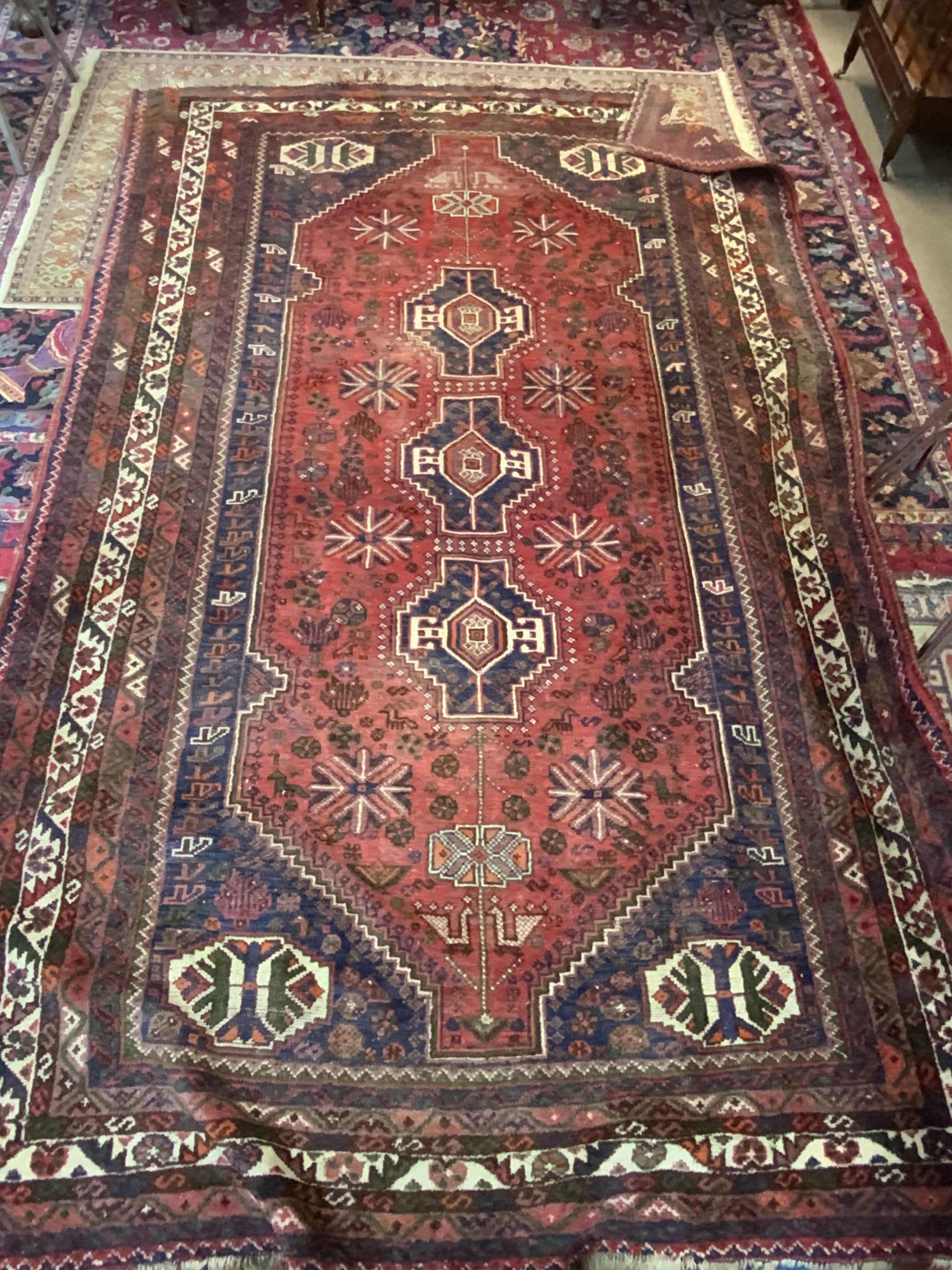 A Large Persian wool rug with geometric design 305cm x 198cm