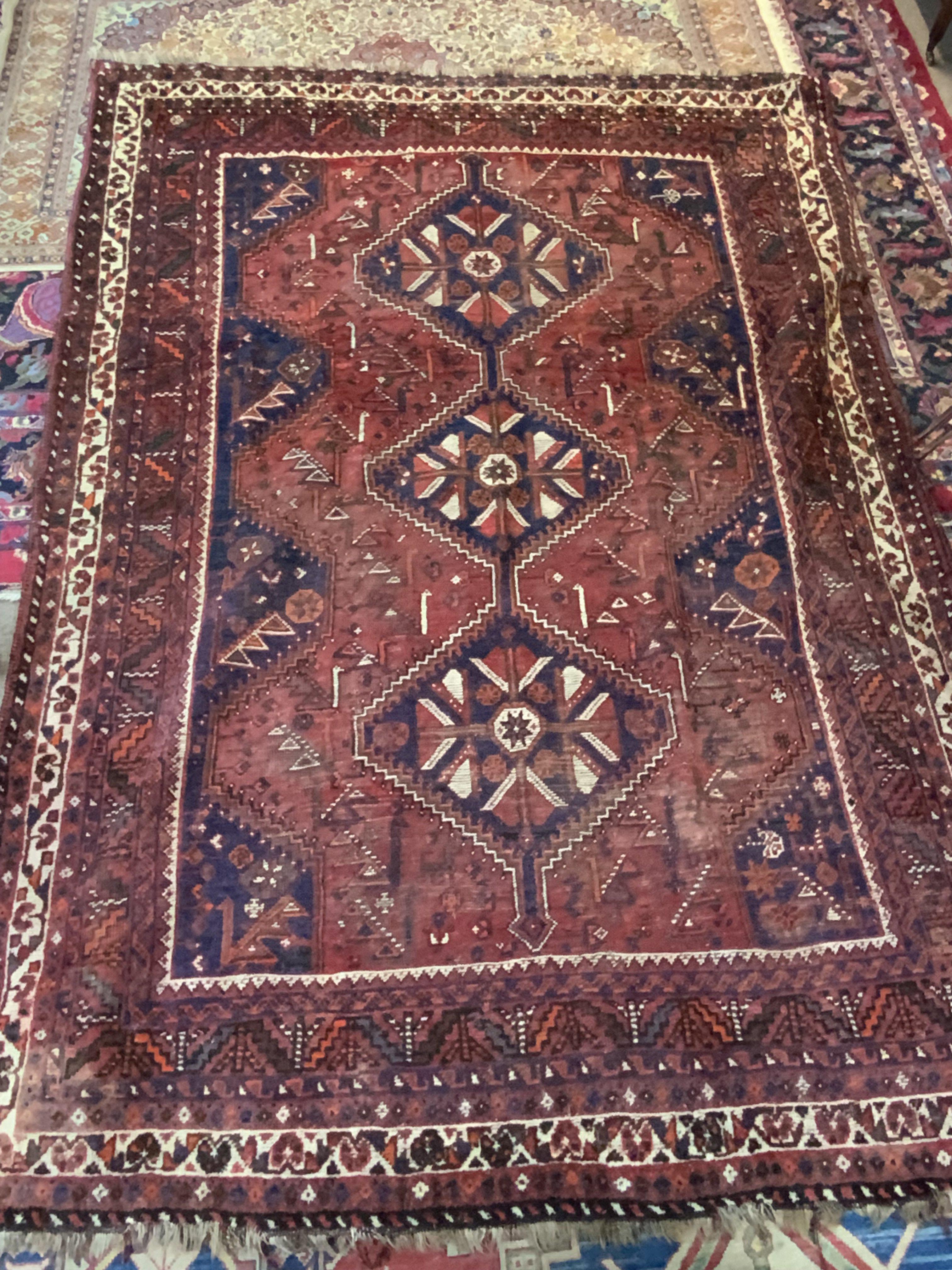 A Large Persian wool rug with geometric design, 260cm x 183cm