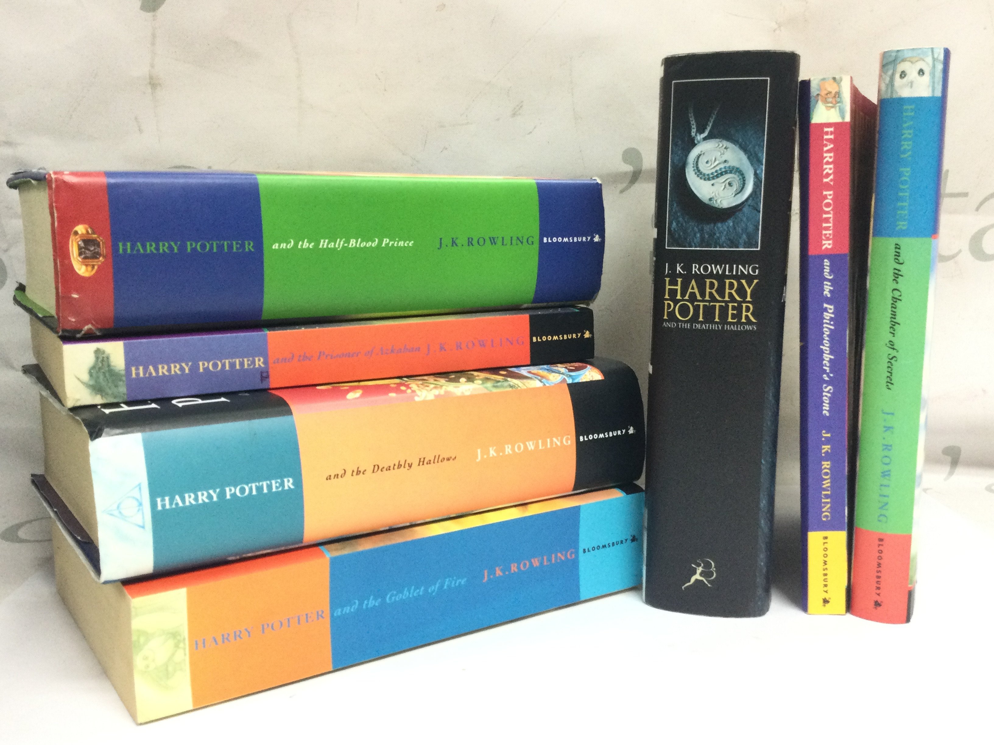 Seven Harry Potter books , three being first editions. Postage category B
