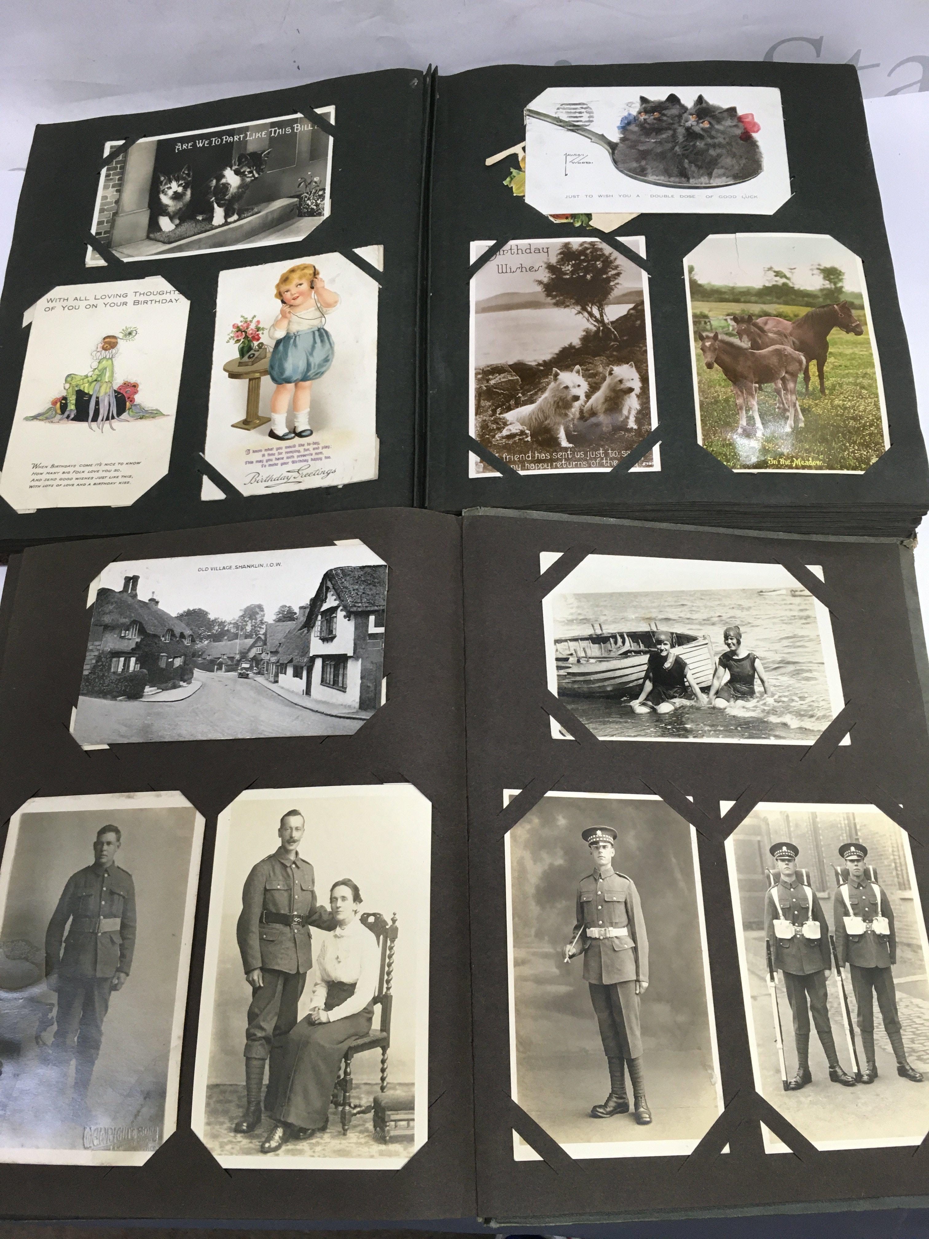 Two postcard albums including military, Mabel Lucie Atwell and others.