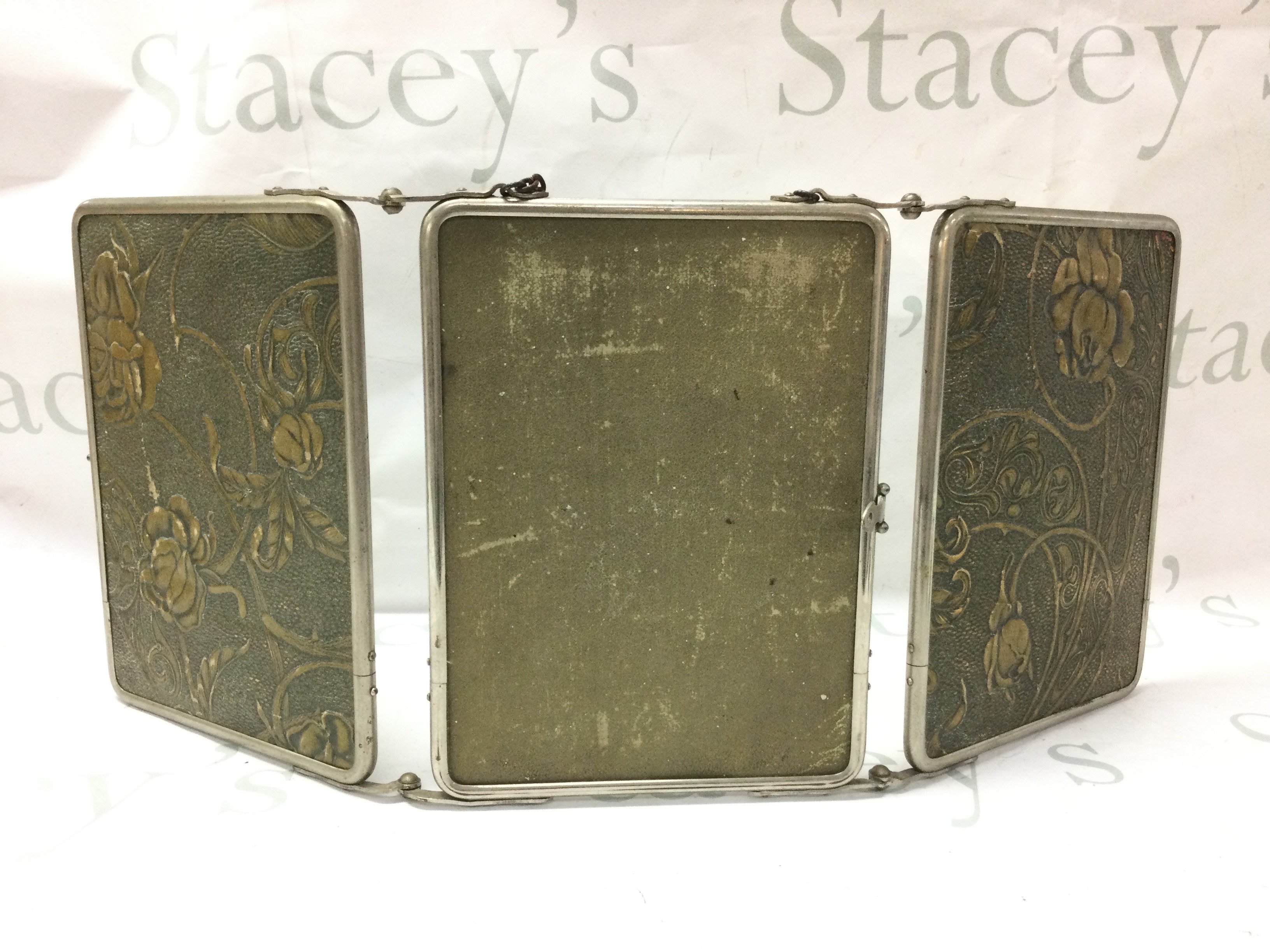 A good vintage three mirror carrying mirror with chain, handle and embossed flower covers. Each panel 18x24cm This lot cannot be posted.NO RESERVE