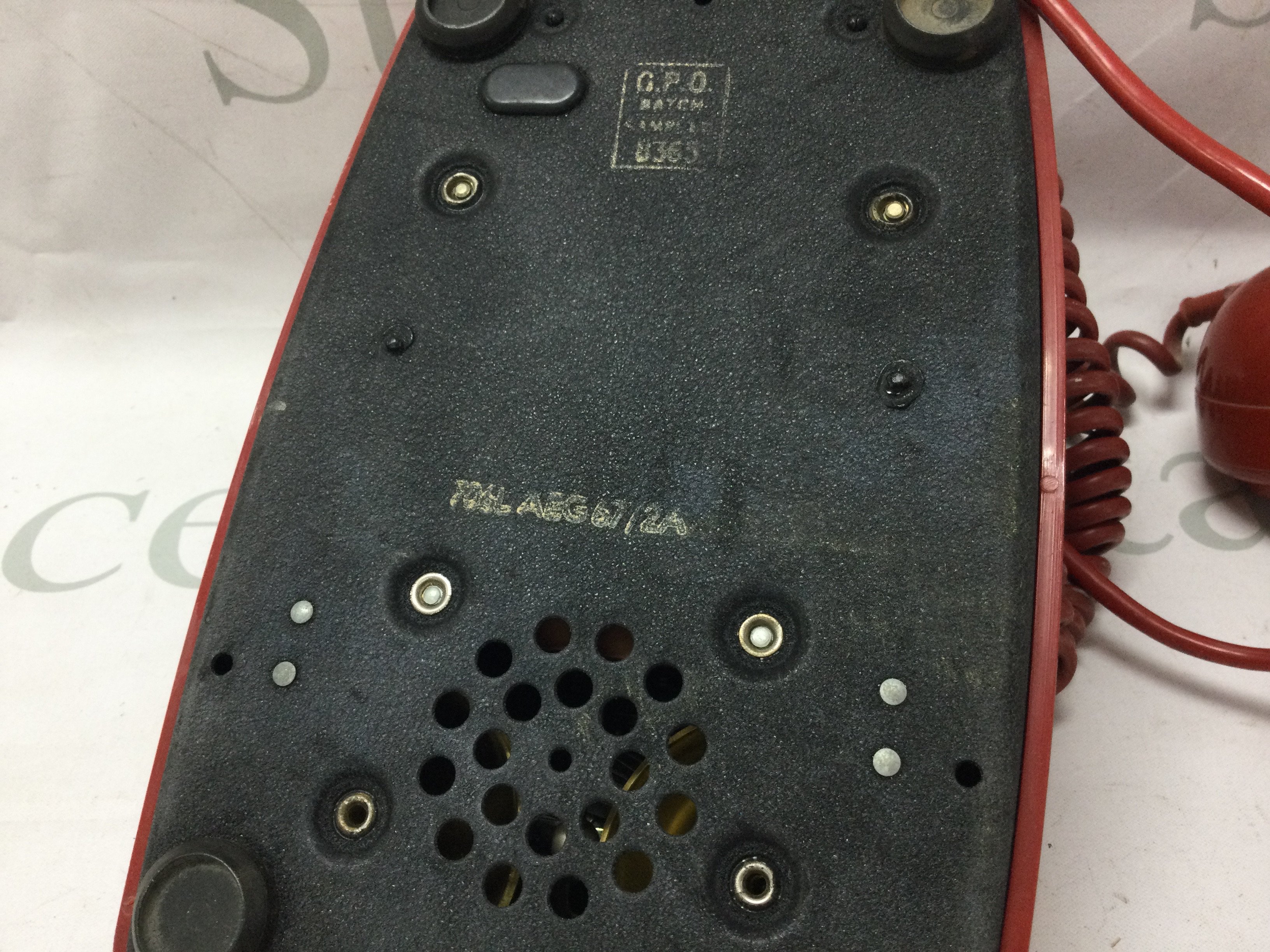 A vintage red telephone . Postage category C. NO RESERVE