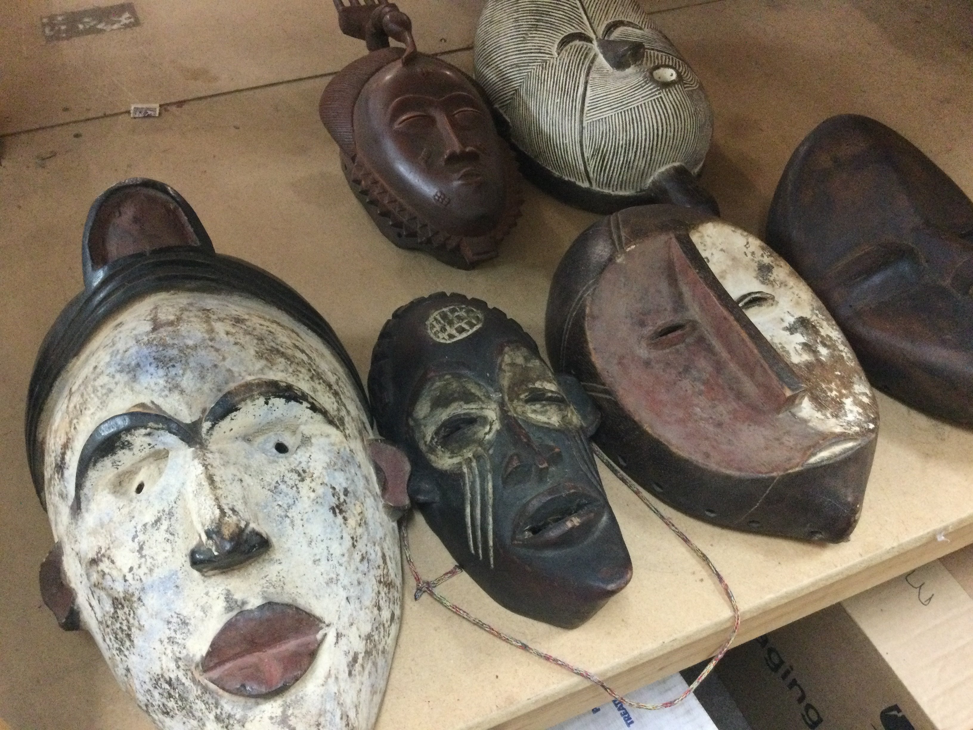 A collection of six triable masks including Republic of Congo , Chokwe and a Dan .