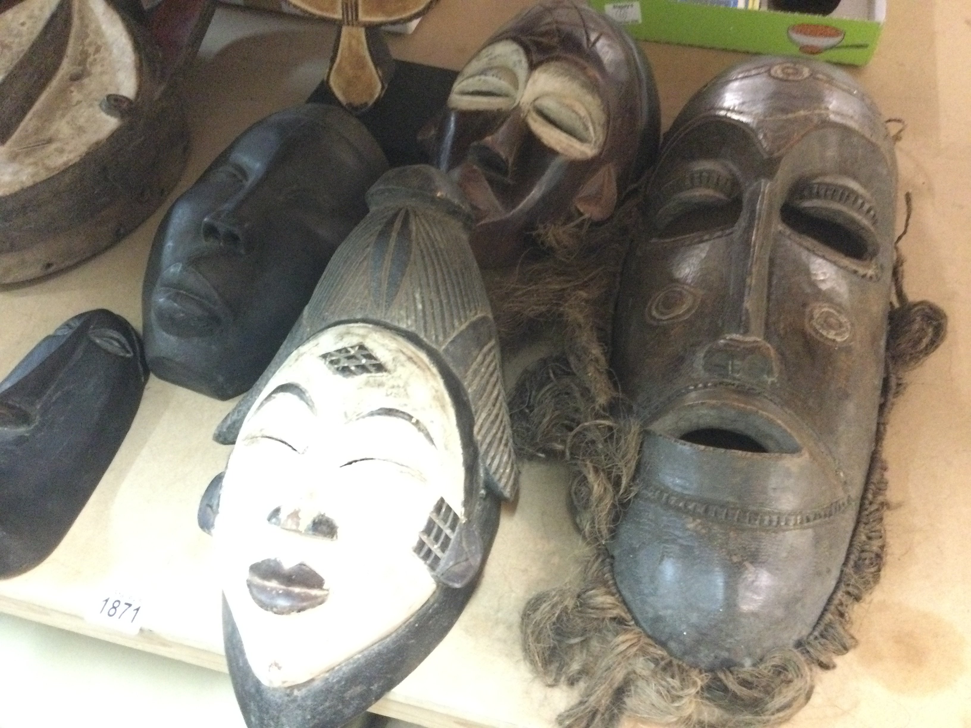A collection of six African tribal masks including Republic of Congo and Chokwe .