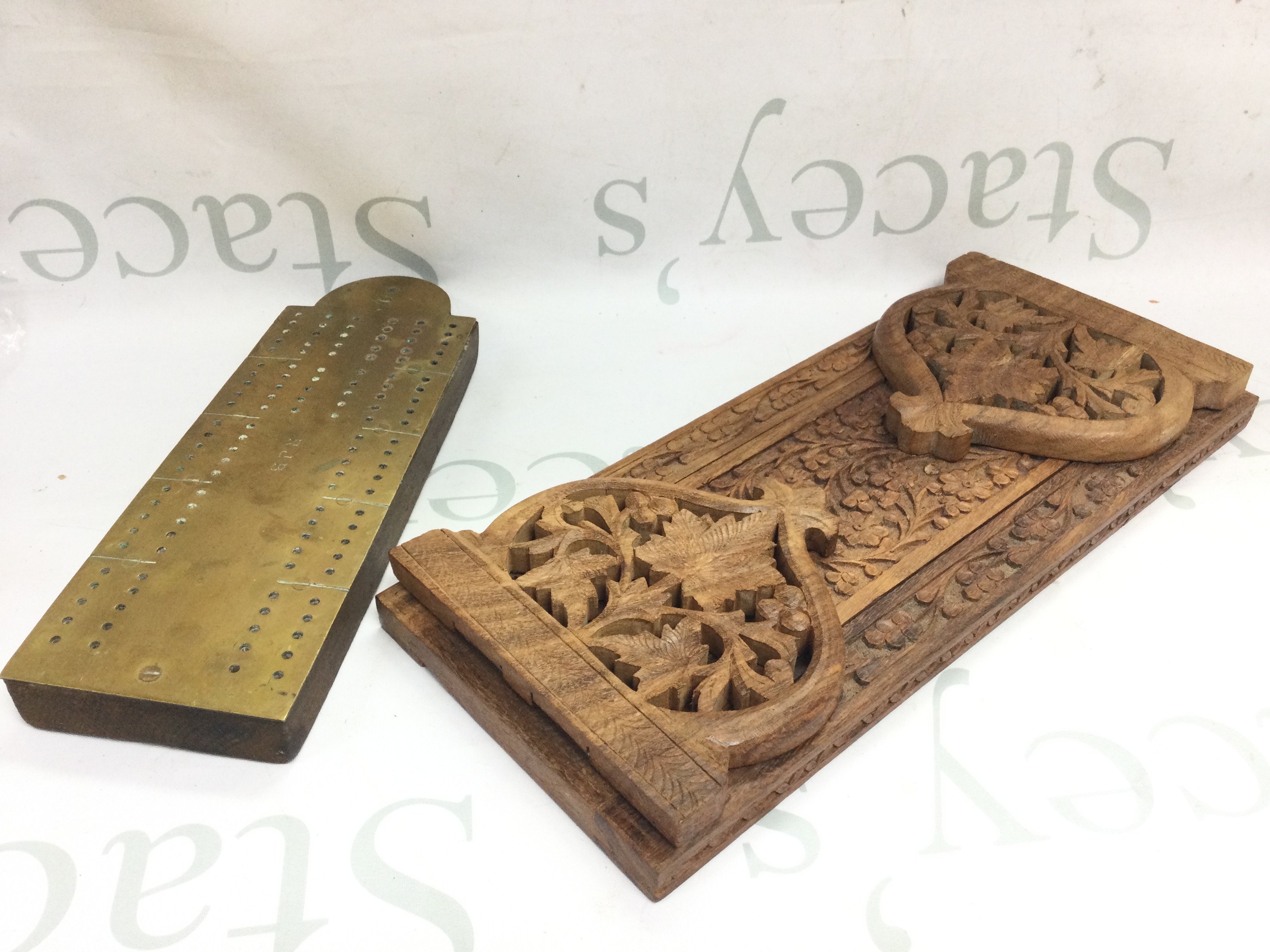 A carved wooden book slide and brass crib board. Postage category b