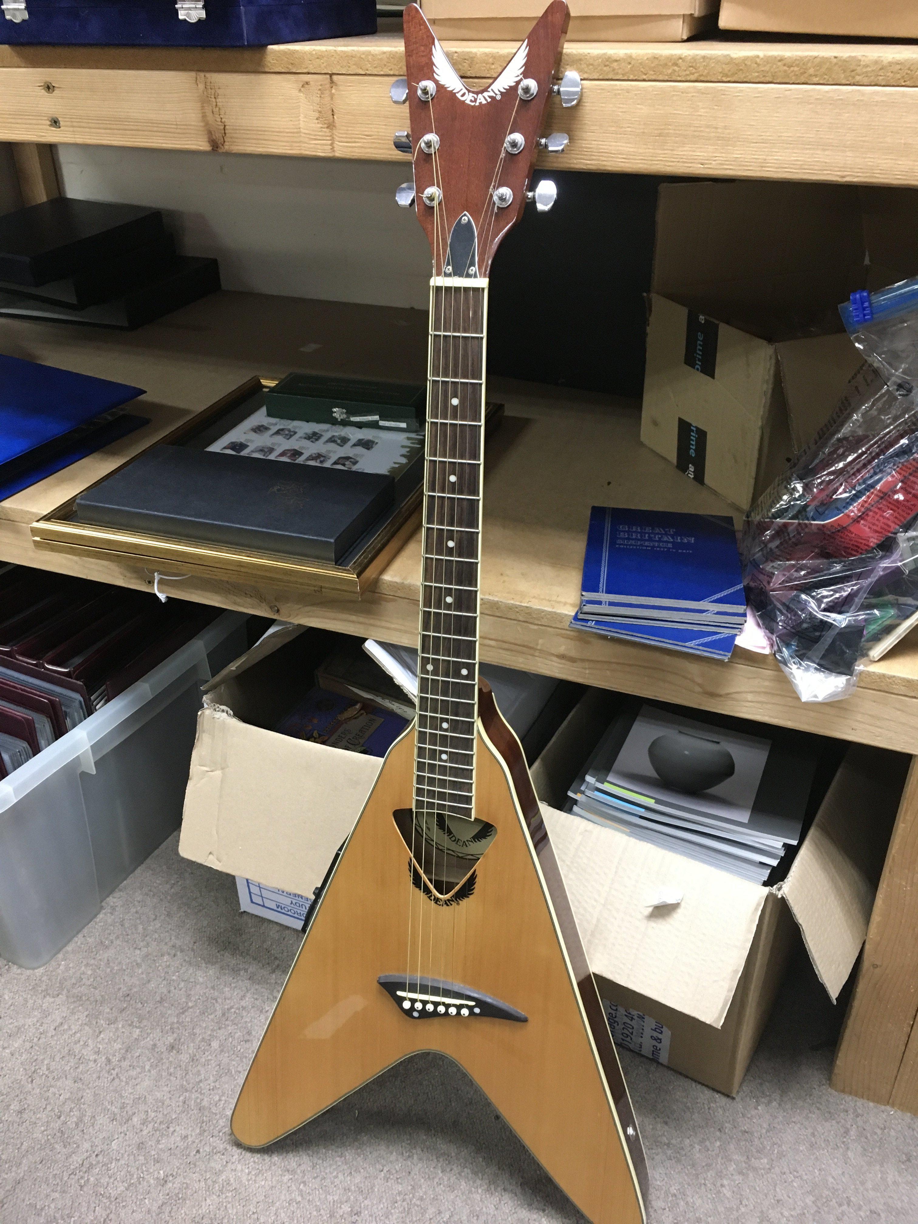 A Dean VCO electro acoustic flying V guitar. No case. No reserve