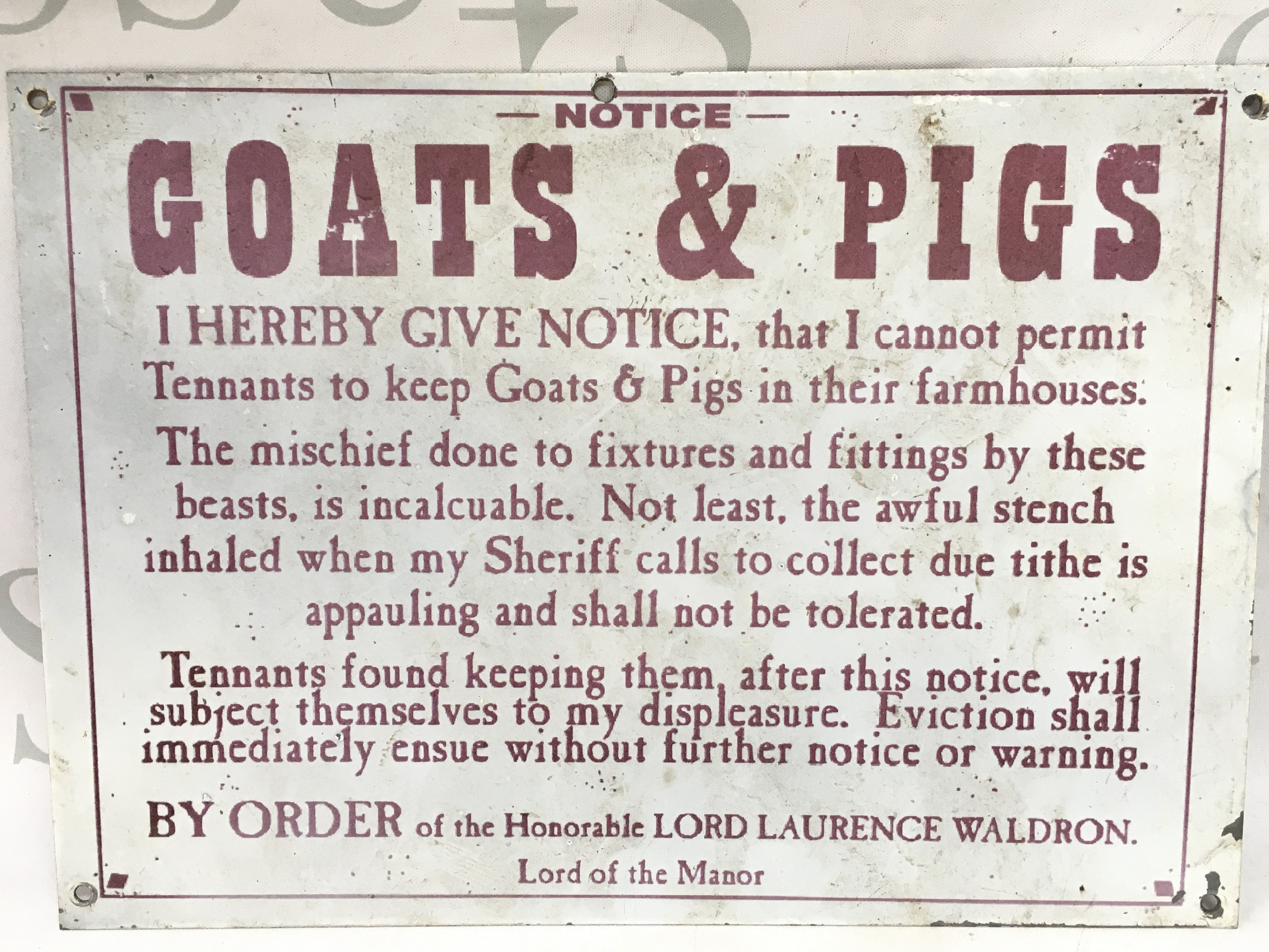 A small metal sign for keeping goats and pigs in farmhouses by Lord Laurence Waldron of the Manor dimensions 29x21cm . Postage category B