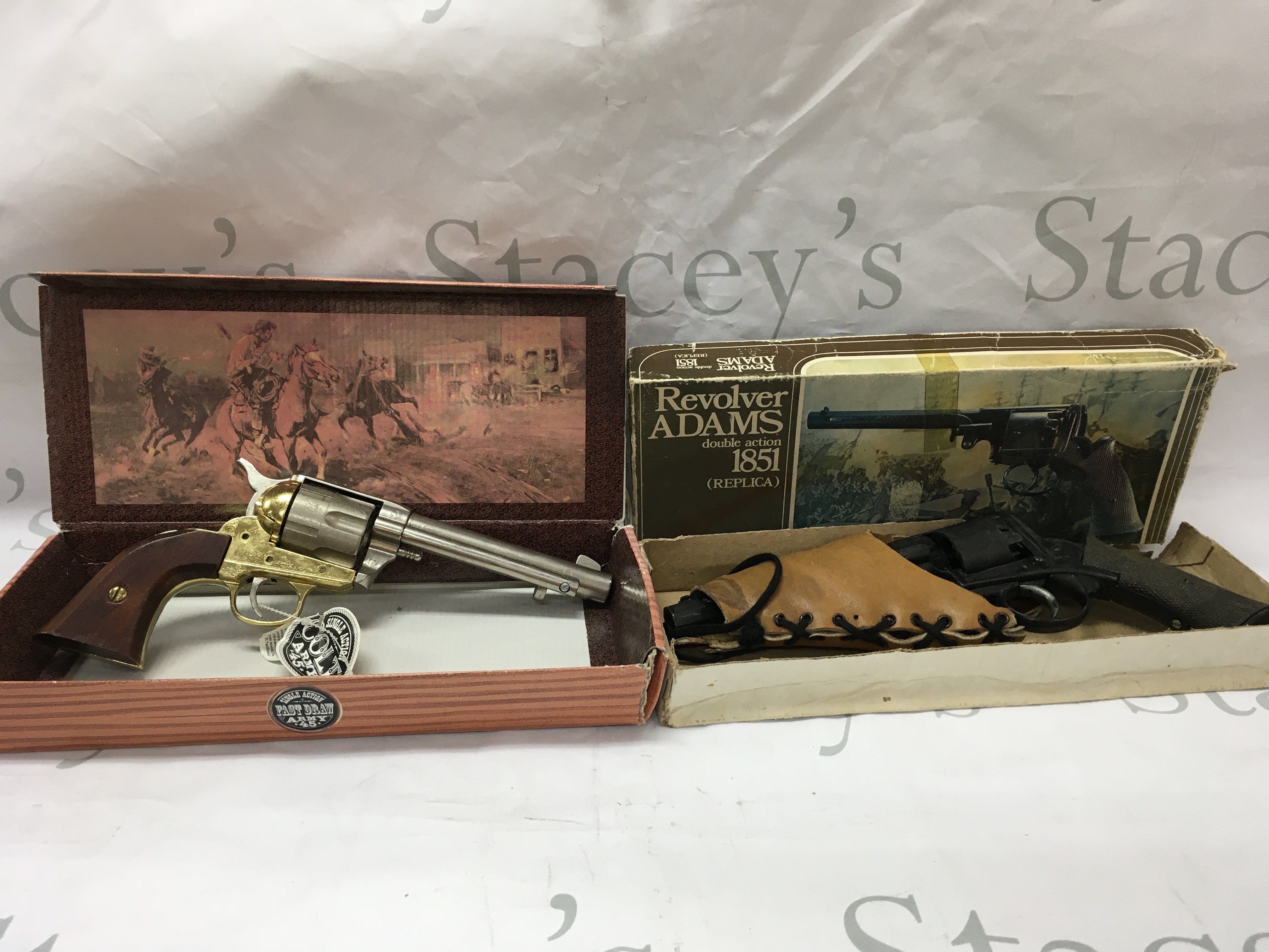 Three replica pistols, including a single action army colt 45, a double action 1851 revolver replica and a Remington style revolver.