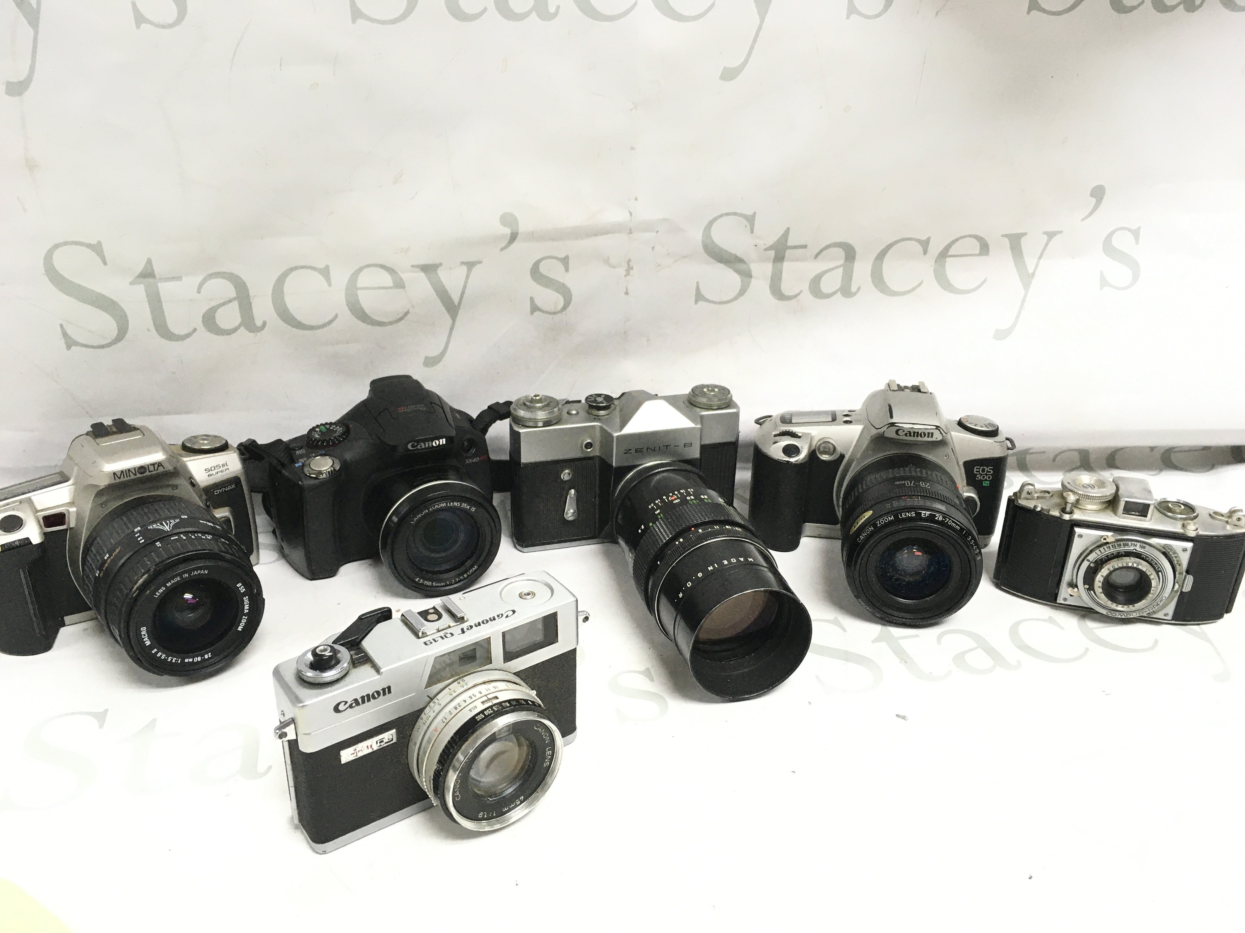 Six vintage cameras including Canon, Minolta, etc. postage cat C