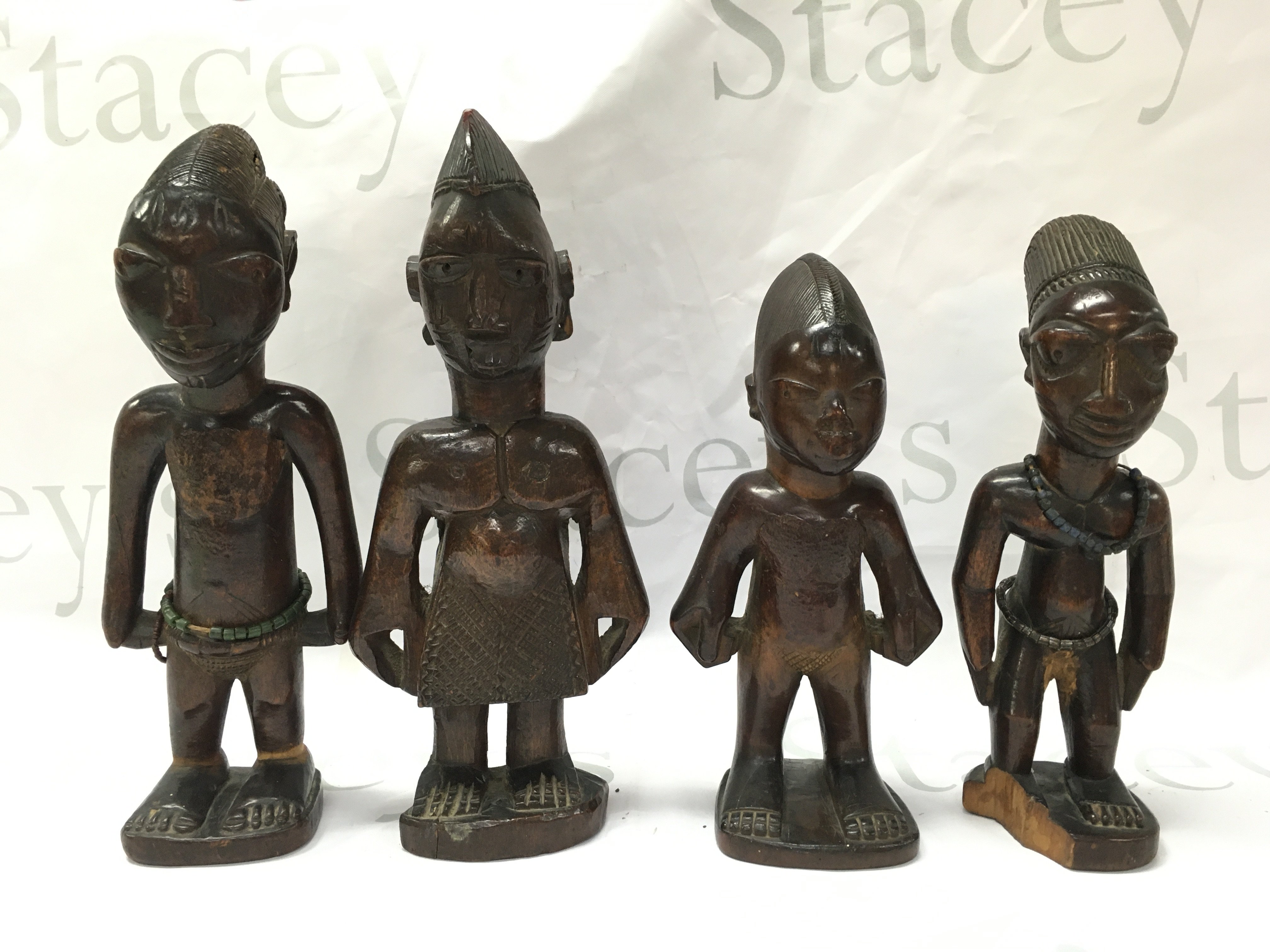 Four caved African wooden figures, believed to be from the Bamabra tribe. 26cm tall. Postage category B