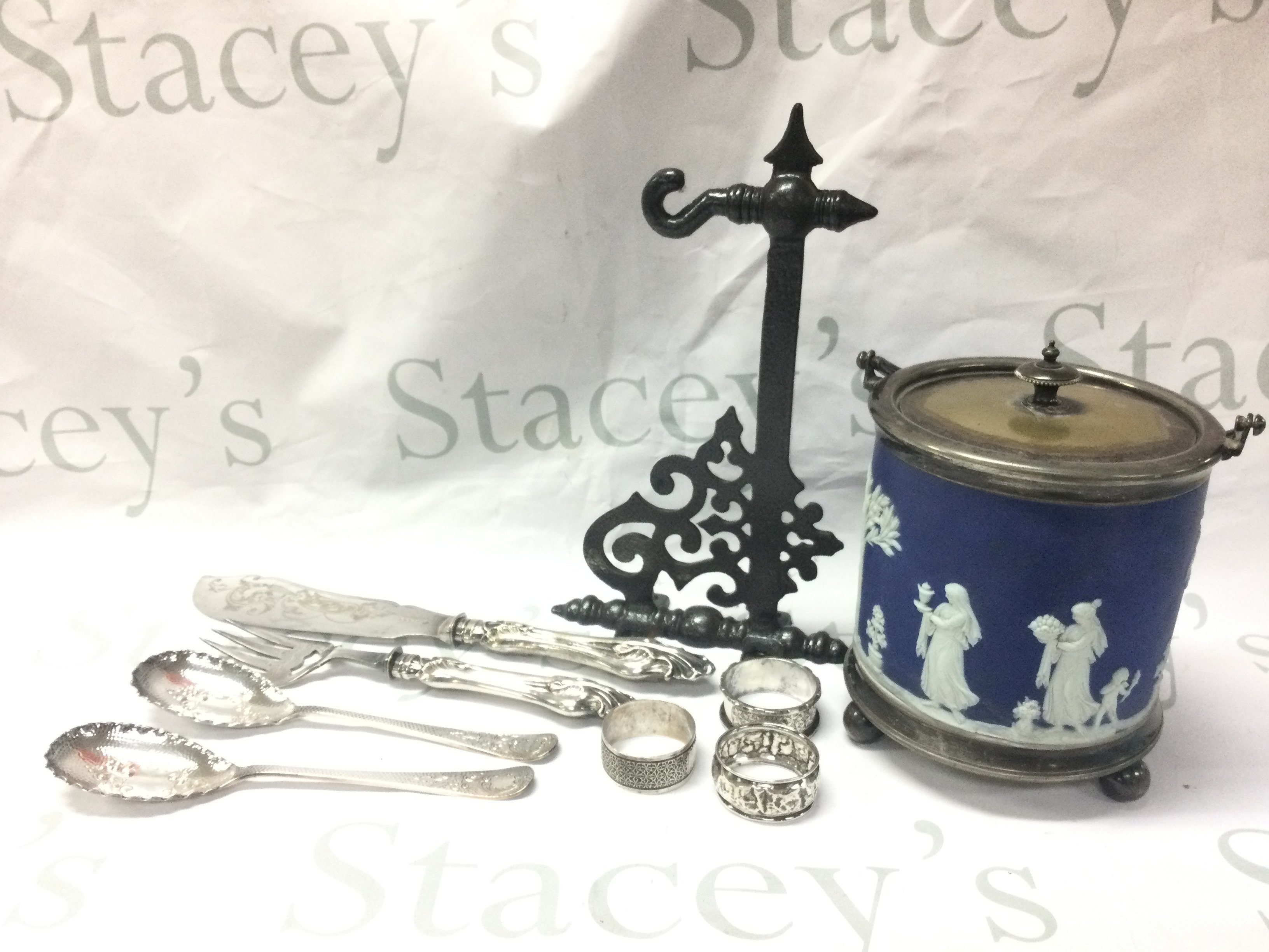 Silver serving spoons , napkin rings, silver plated serving fish slice, Wedgwood biscuit barrel , hanging basket bracket. This lot cannot be posted
