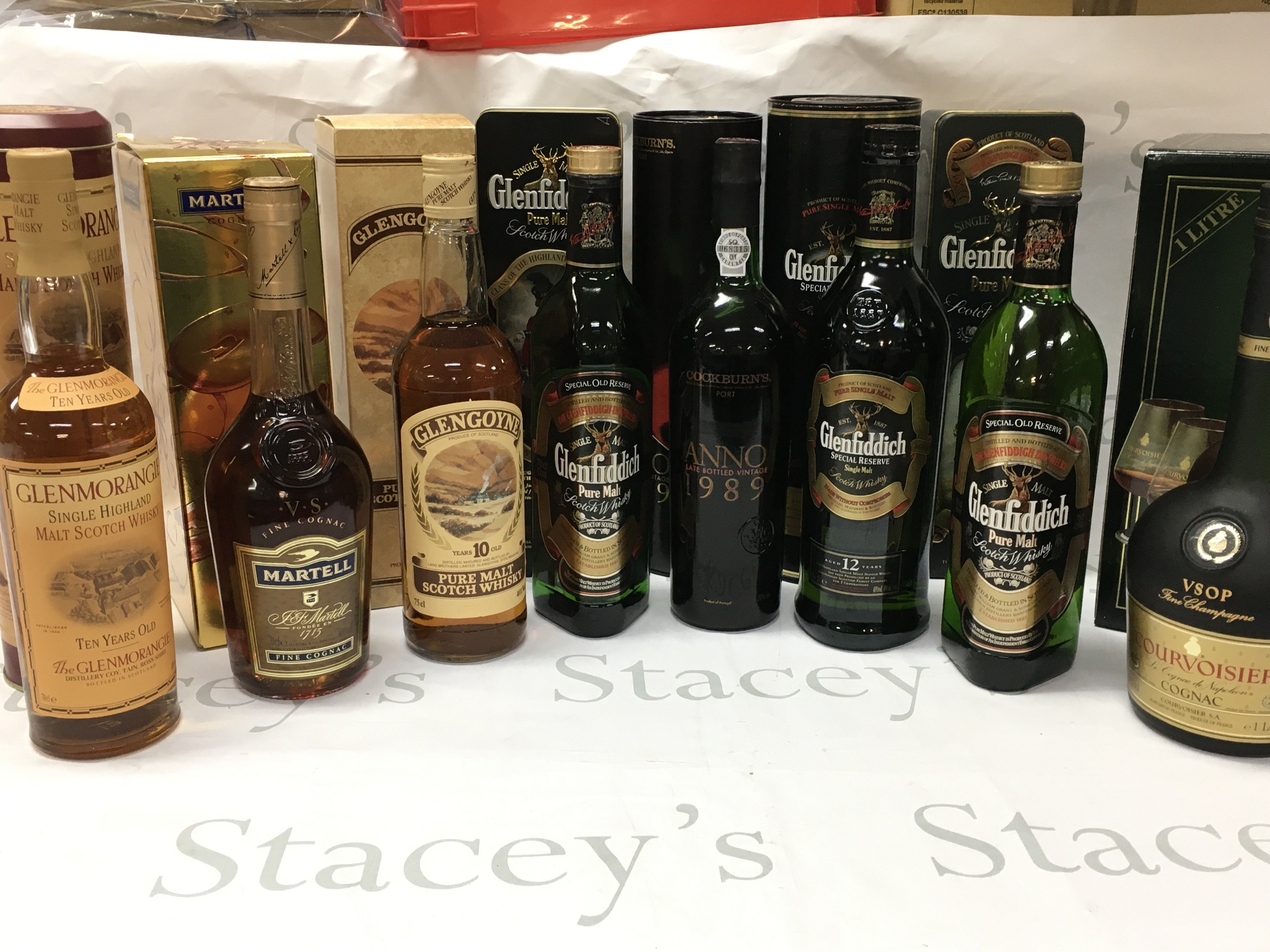 A Collection of boxed whiskey including Glenfiddich single malt , Cockburns 1989 port, Courvoisier fine champagne . This lot cannot be posted